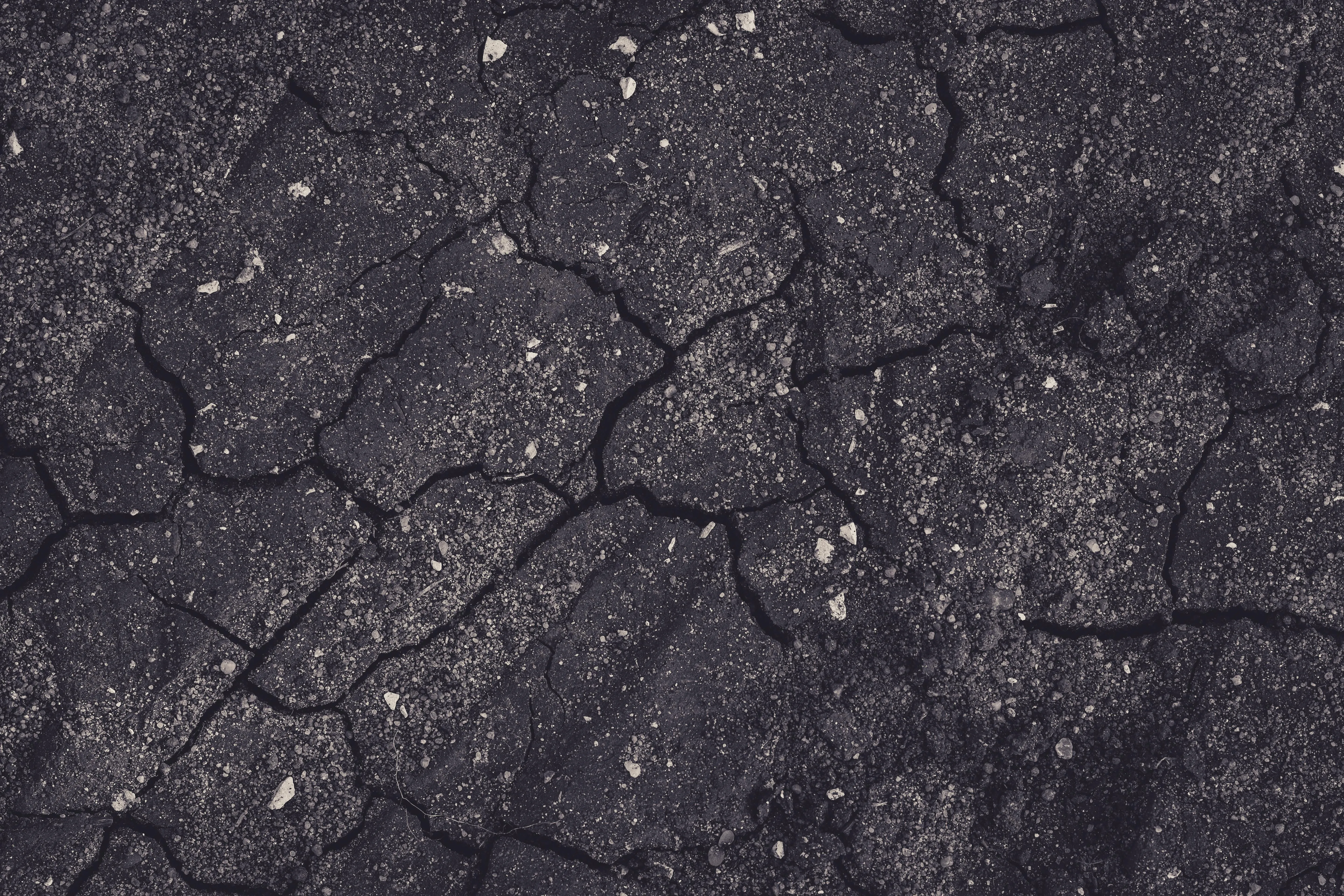 Cracked dark soil texture close up Background Wallpaper