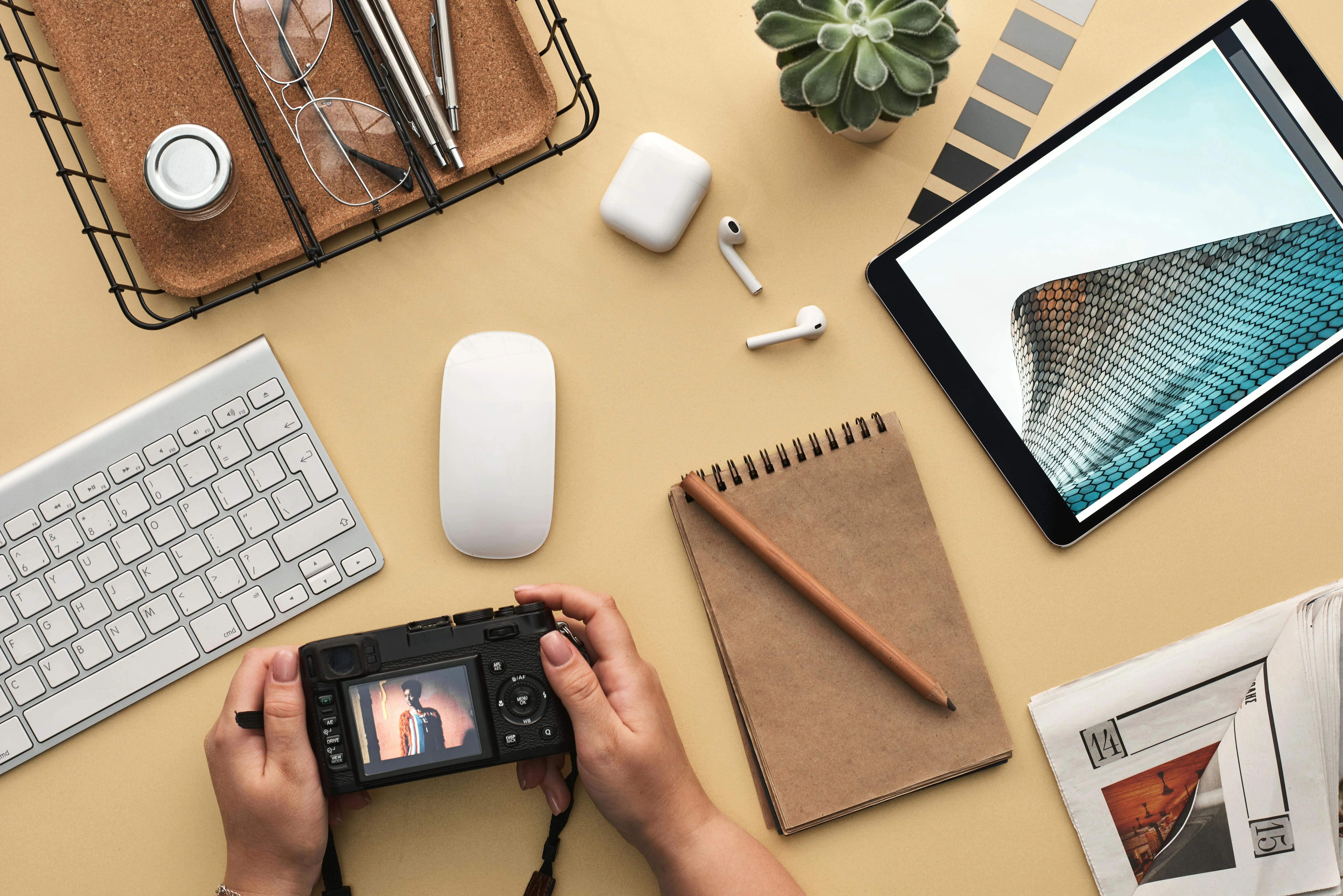 Creative workspace with camera tablet notebook and keyboard