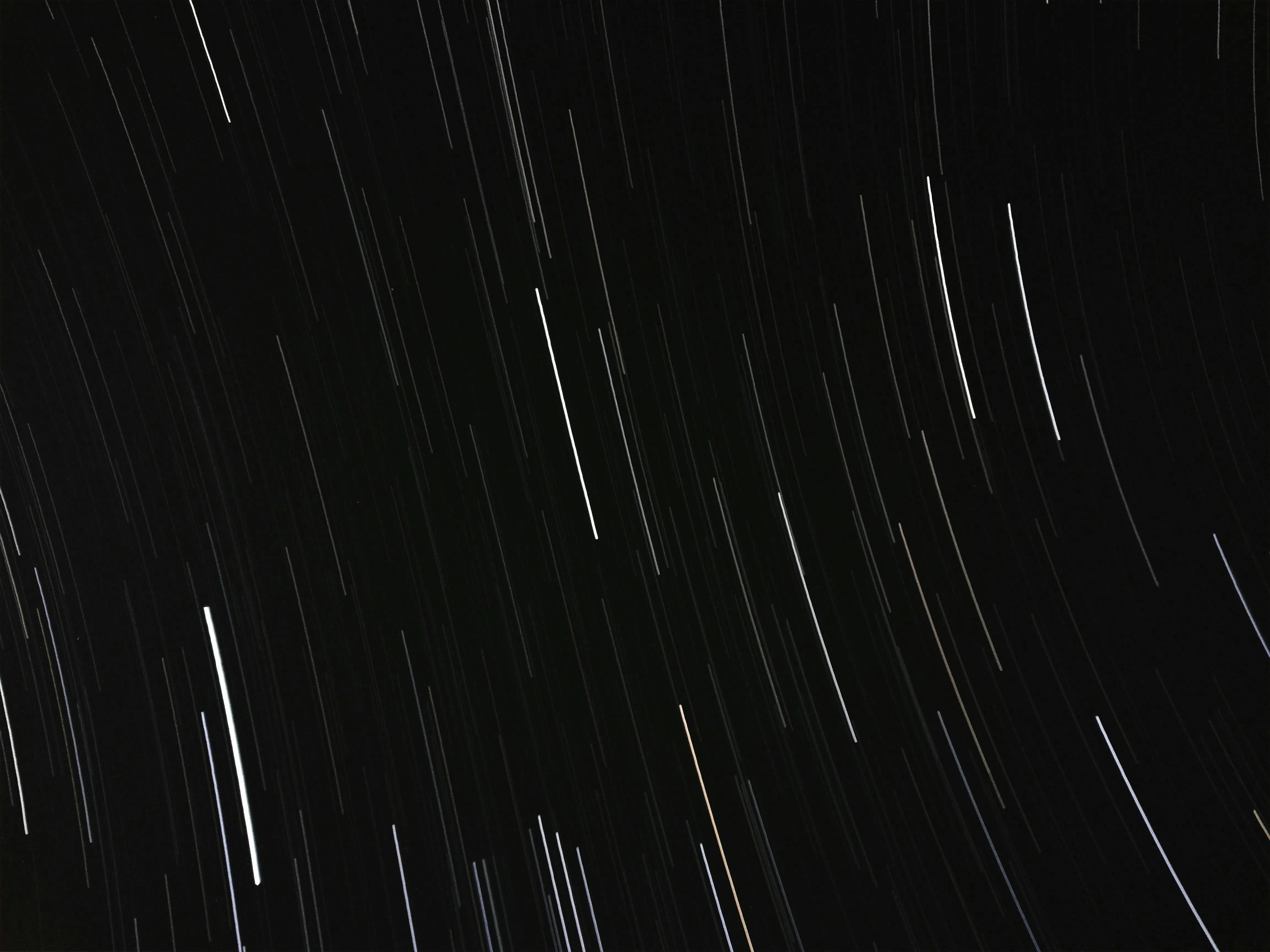 Curved white strip line against a black background image