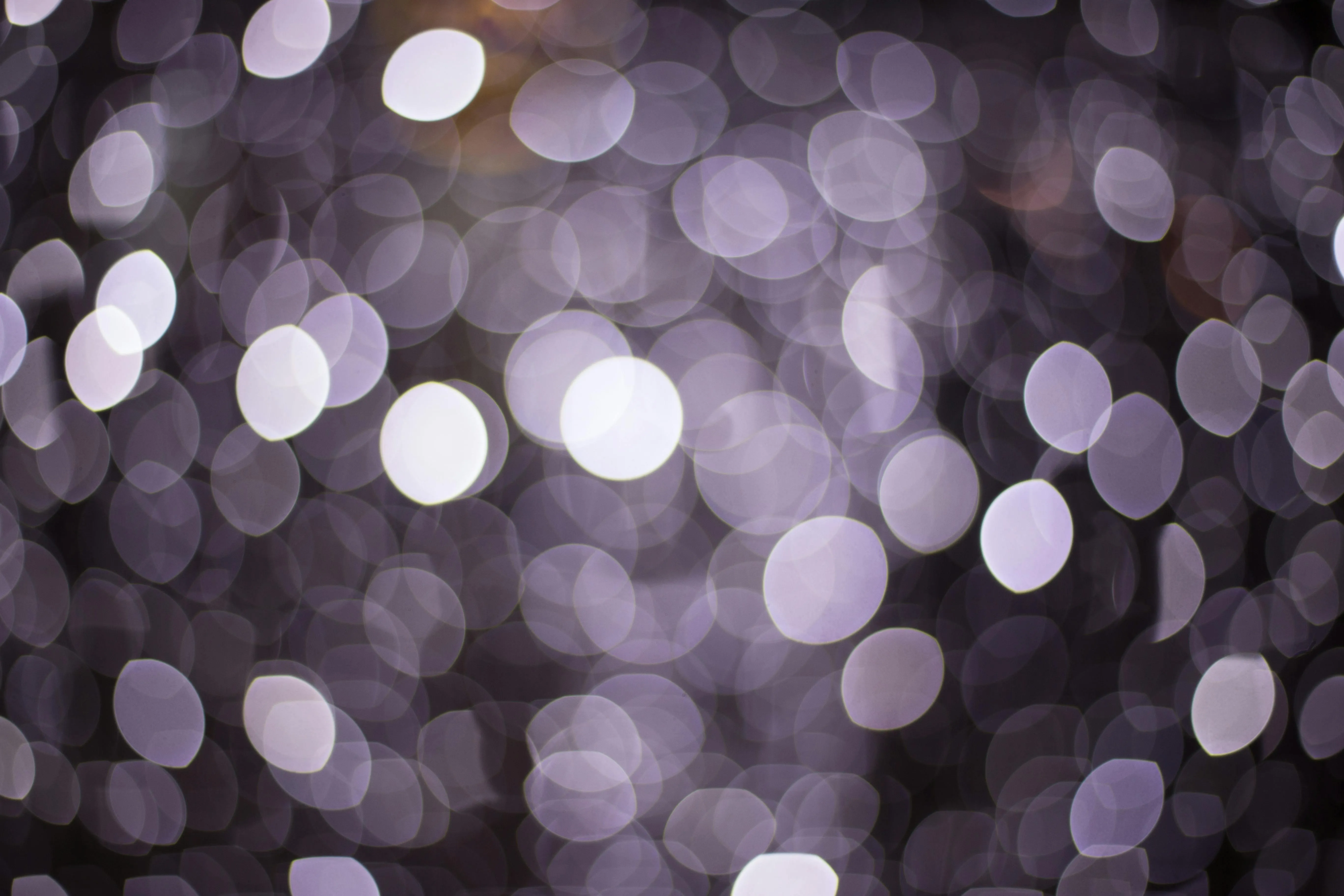 Dark background with soft purple focused bokeh lights image