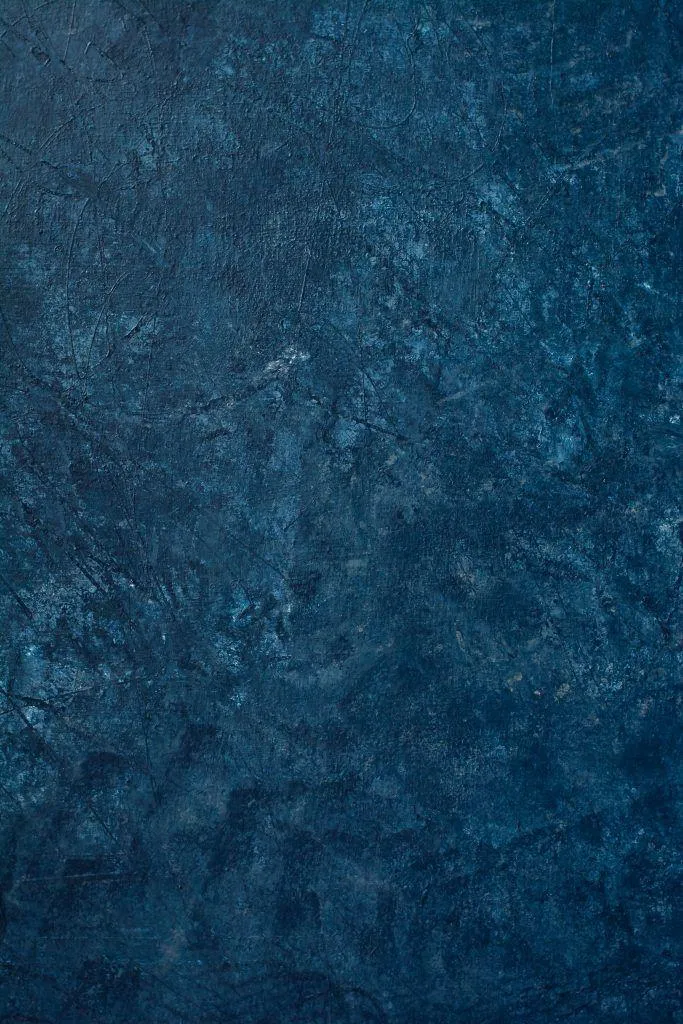 Dark blue textured background with rough artistic surface