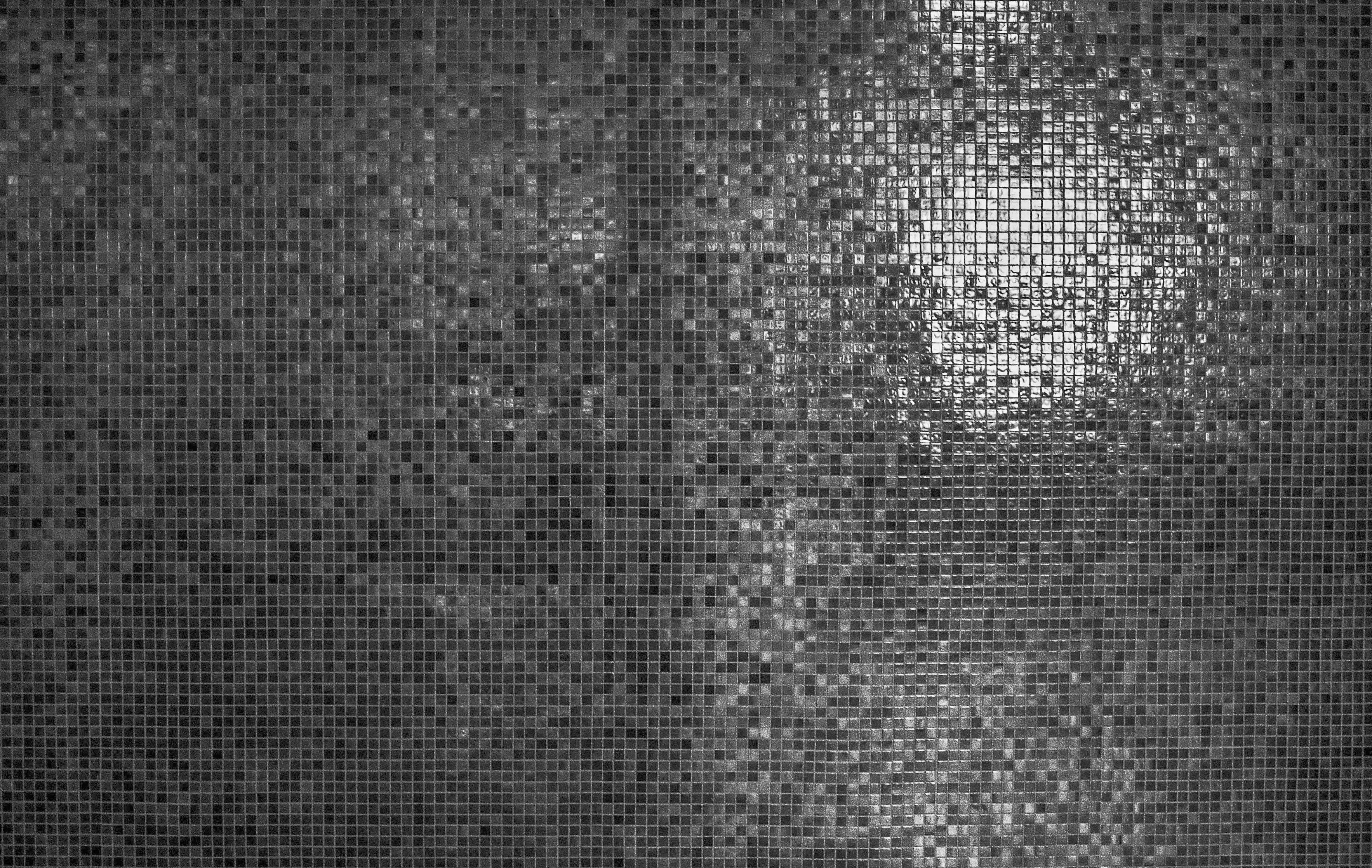 Dark textured metal surface with light reflections Wallpaper