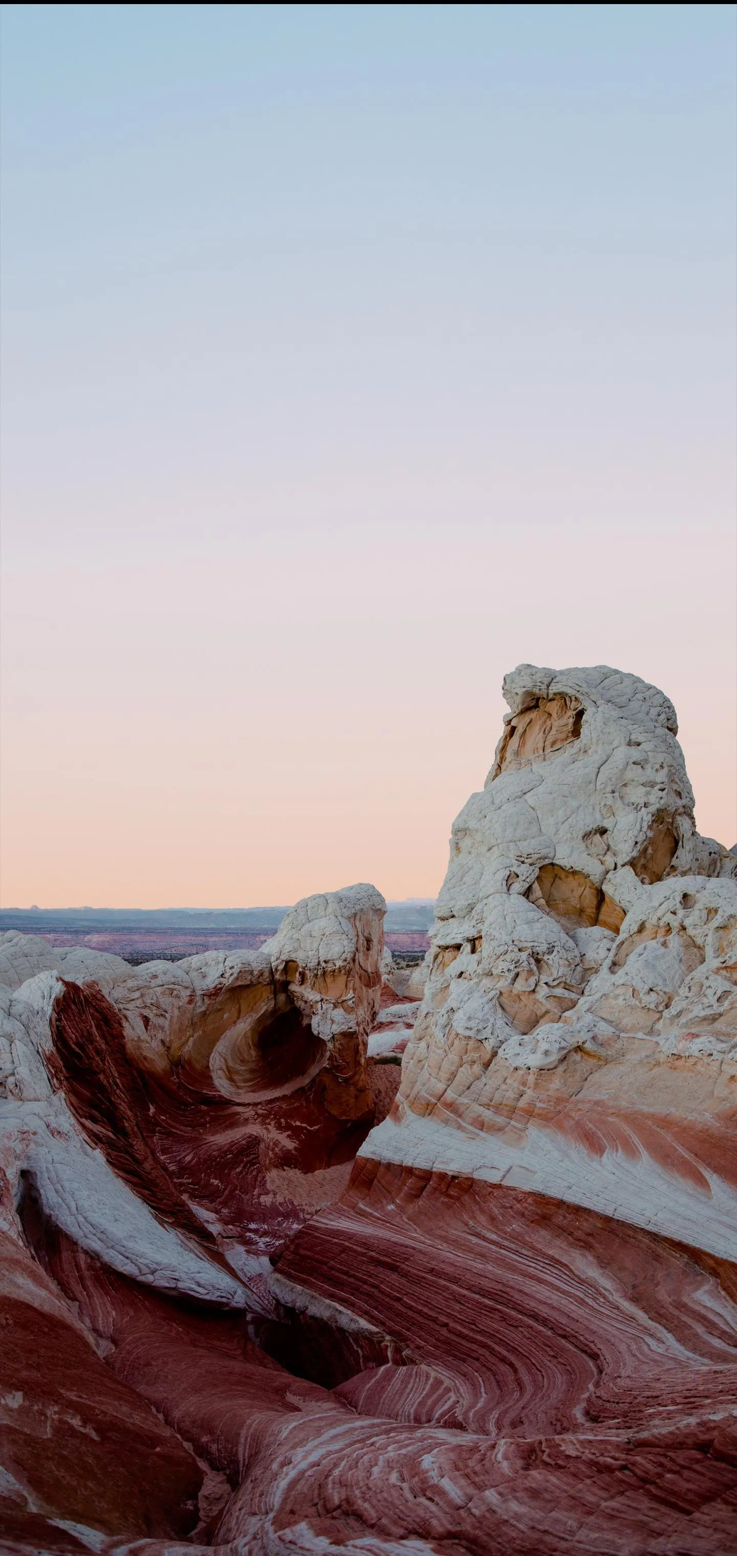 Dramatic Rock Formation Under a Peaceful Sunset Sky