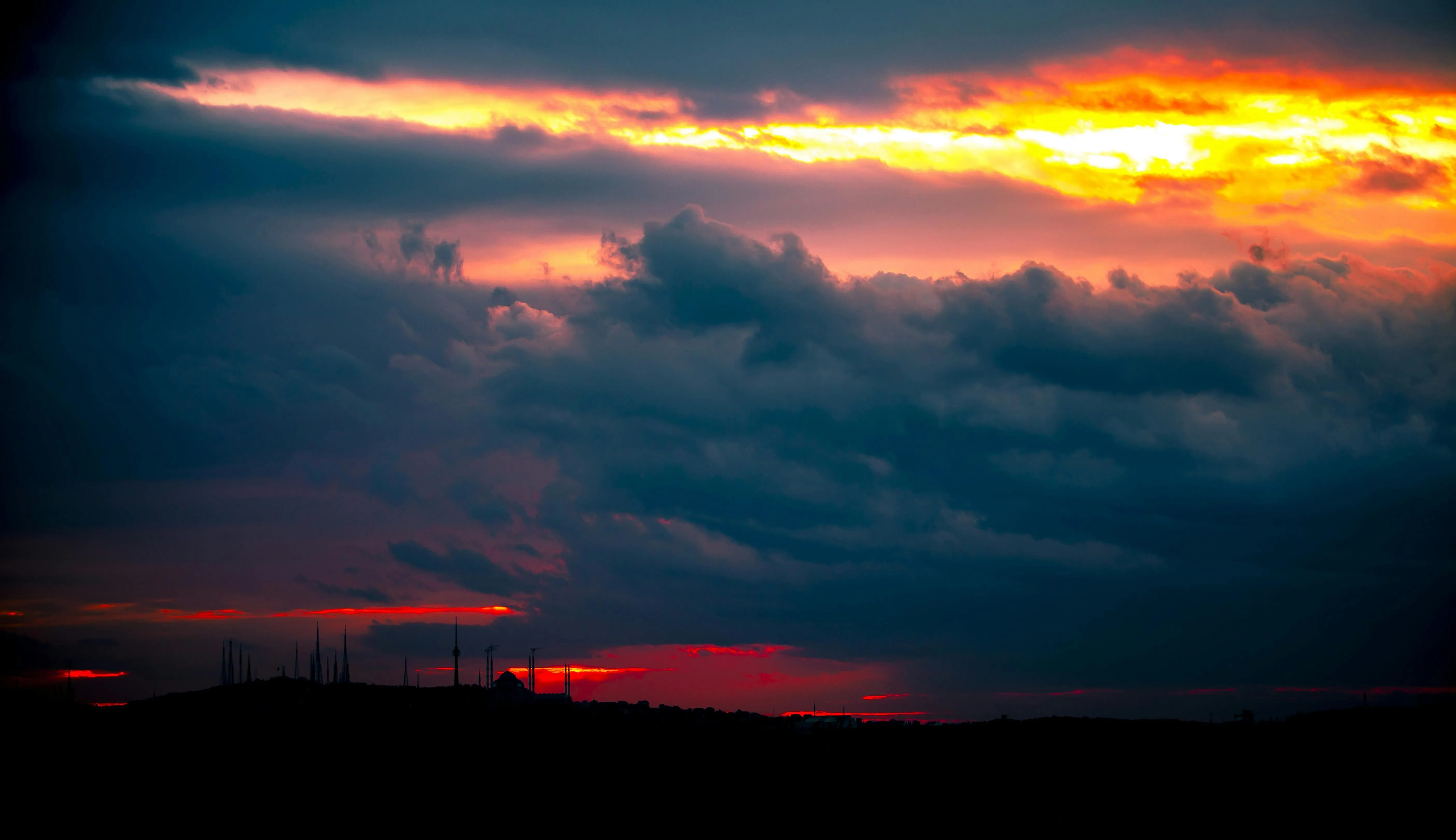 Dramatic sunset with dark clouds and fiery orange sky image