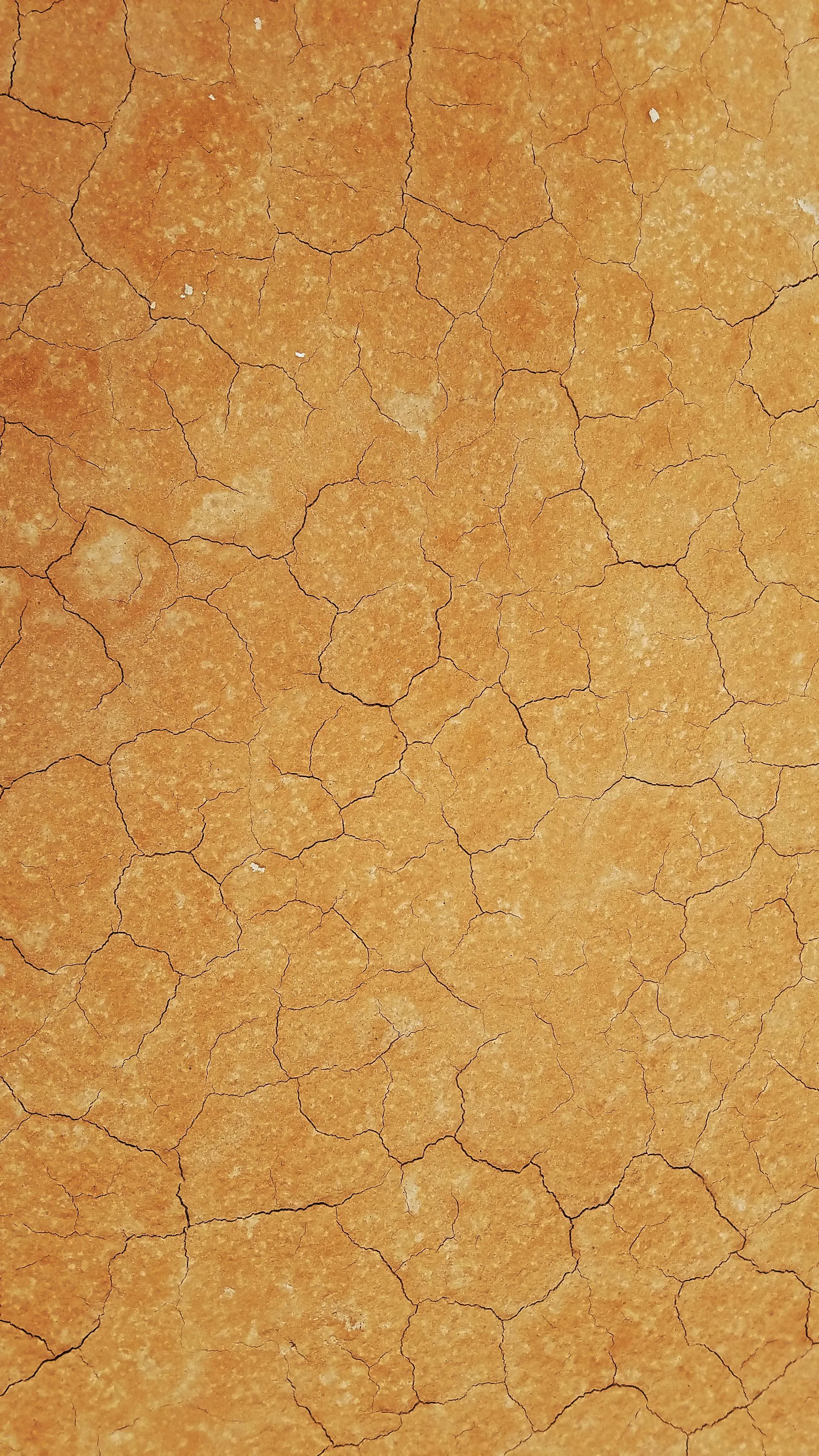 Dry cracked orange earth texture Background 4K Wallpaper
