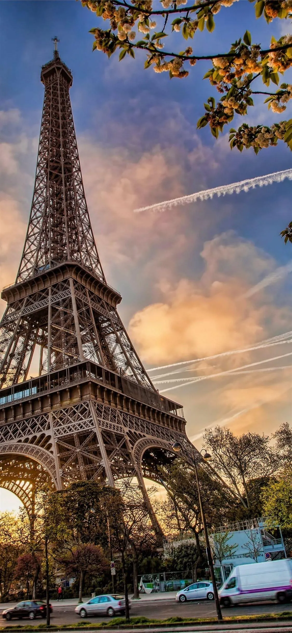 Eiffel Tower at Sunset with Warm Sky and Cityscape Wallpaper