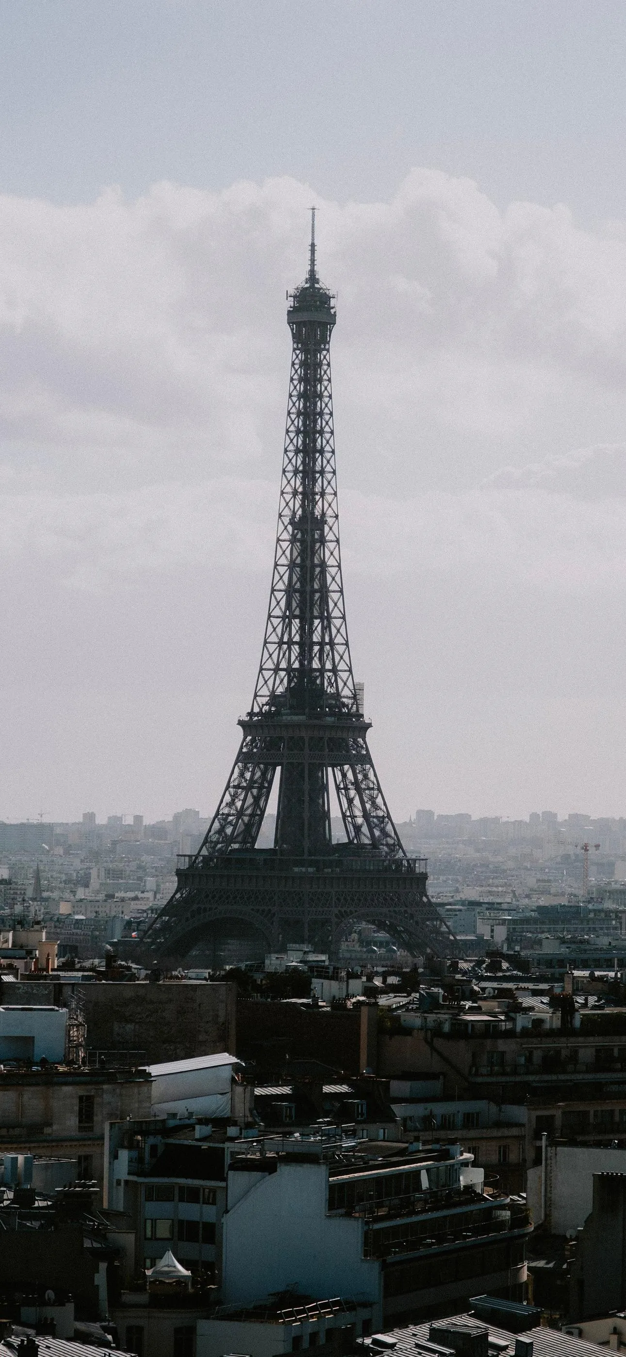 Eiffel Tower Under Cloudy Sky Captured from Low Angle
