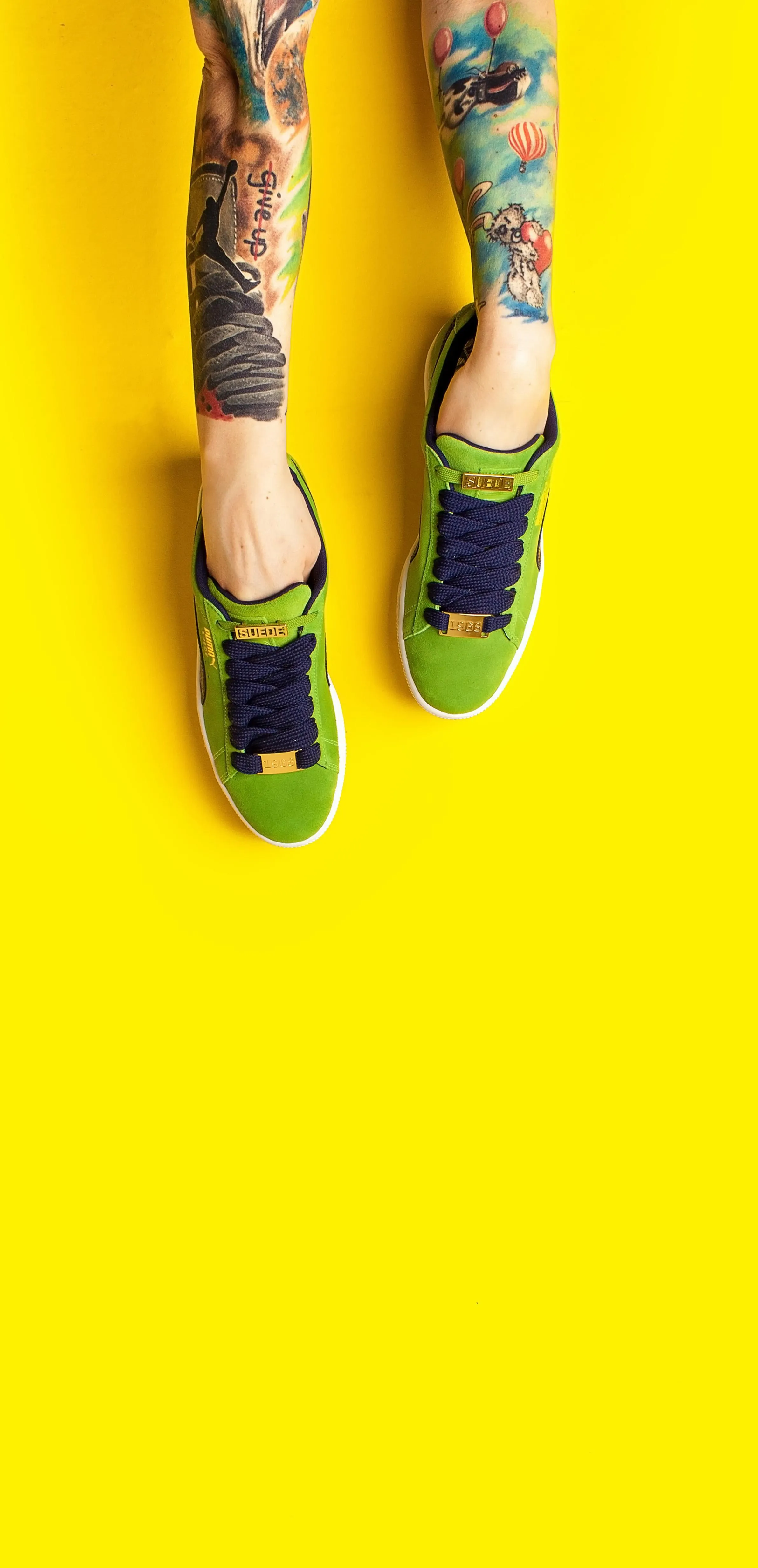 Feet in Yellow Shoes Standing on Bright Yellow Background