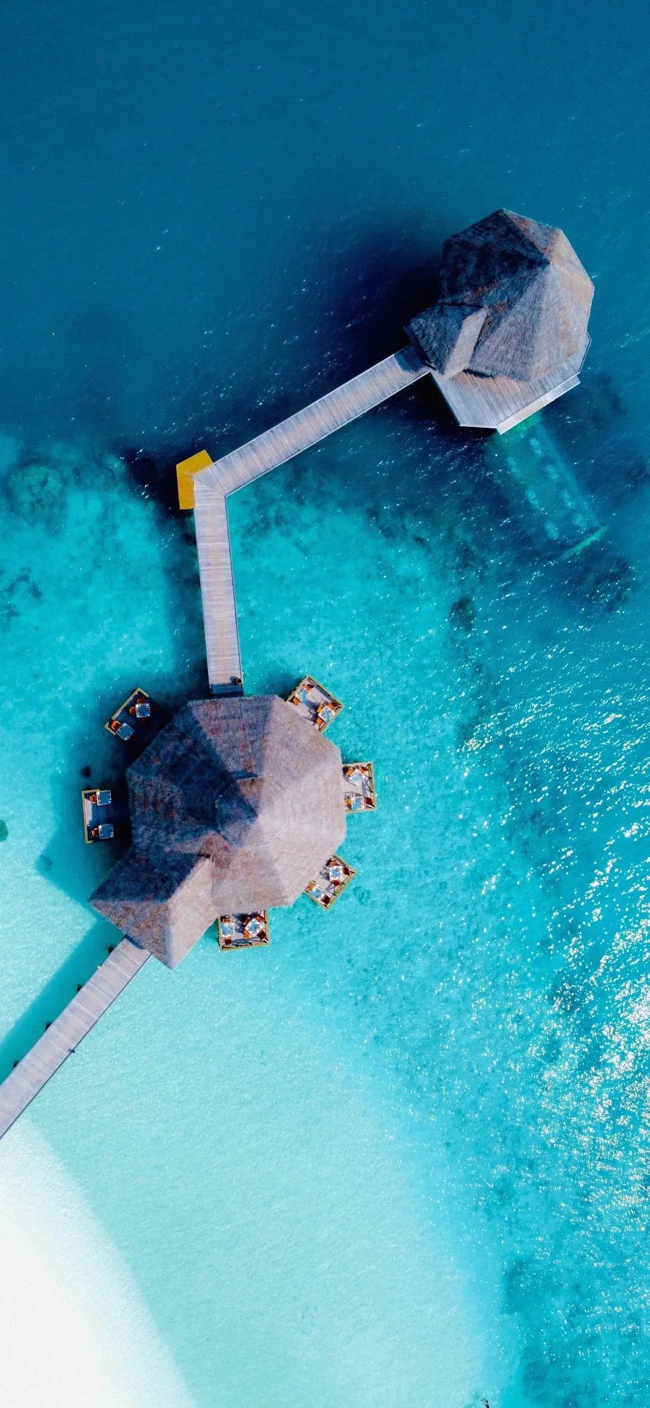 Floating Cabin in Blue Pool Water Captured from Above