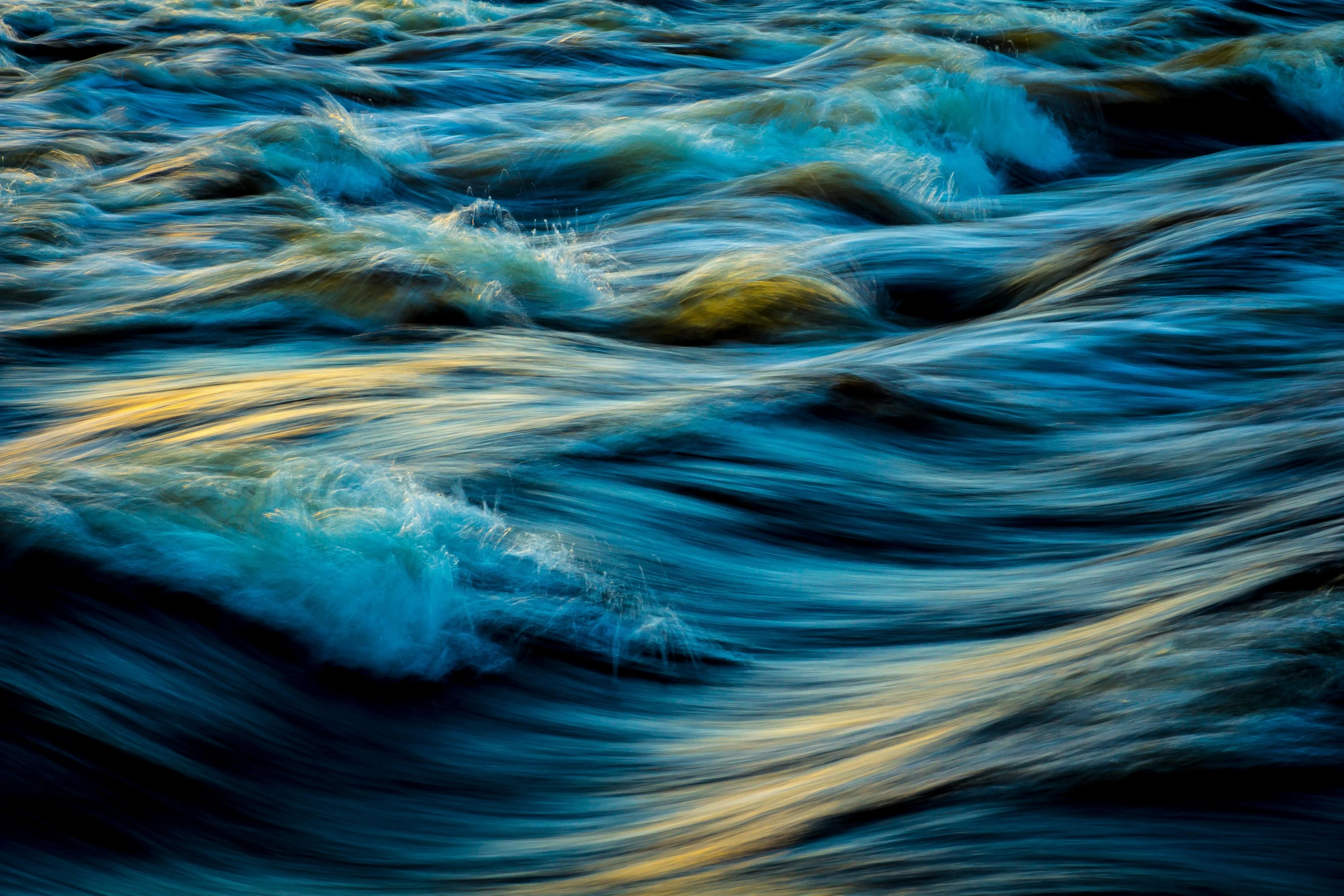 Flowing blue water waves with dynamic movement and texture
