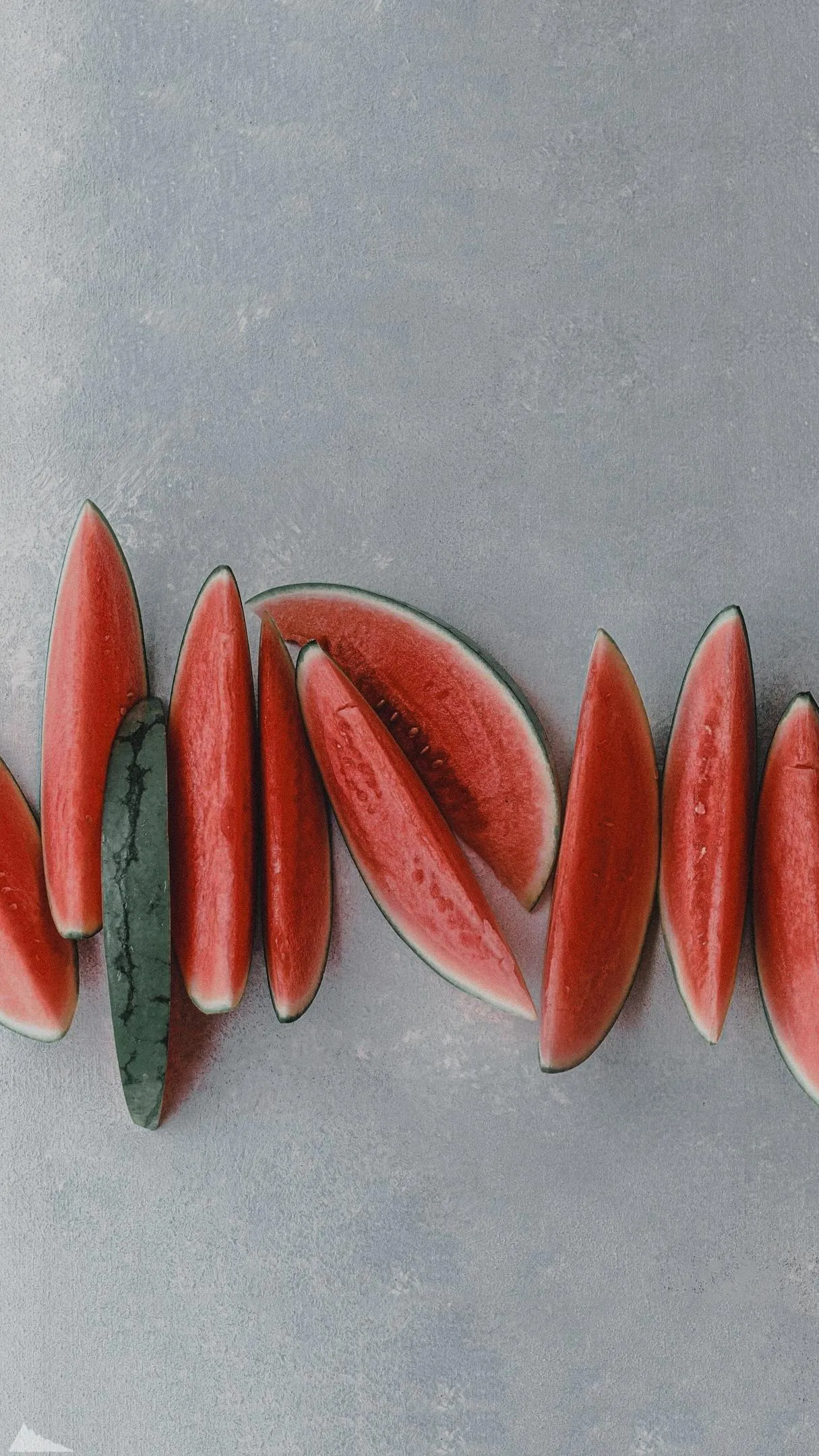 Freshly Sliced Watermelon Wedges on a Cool Grey Surface