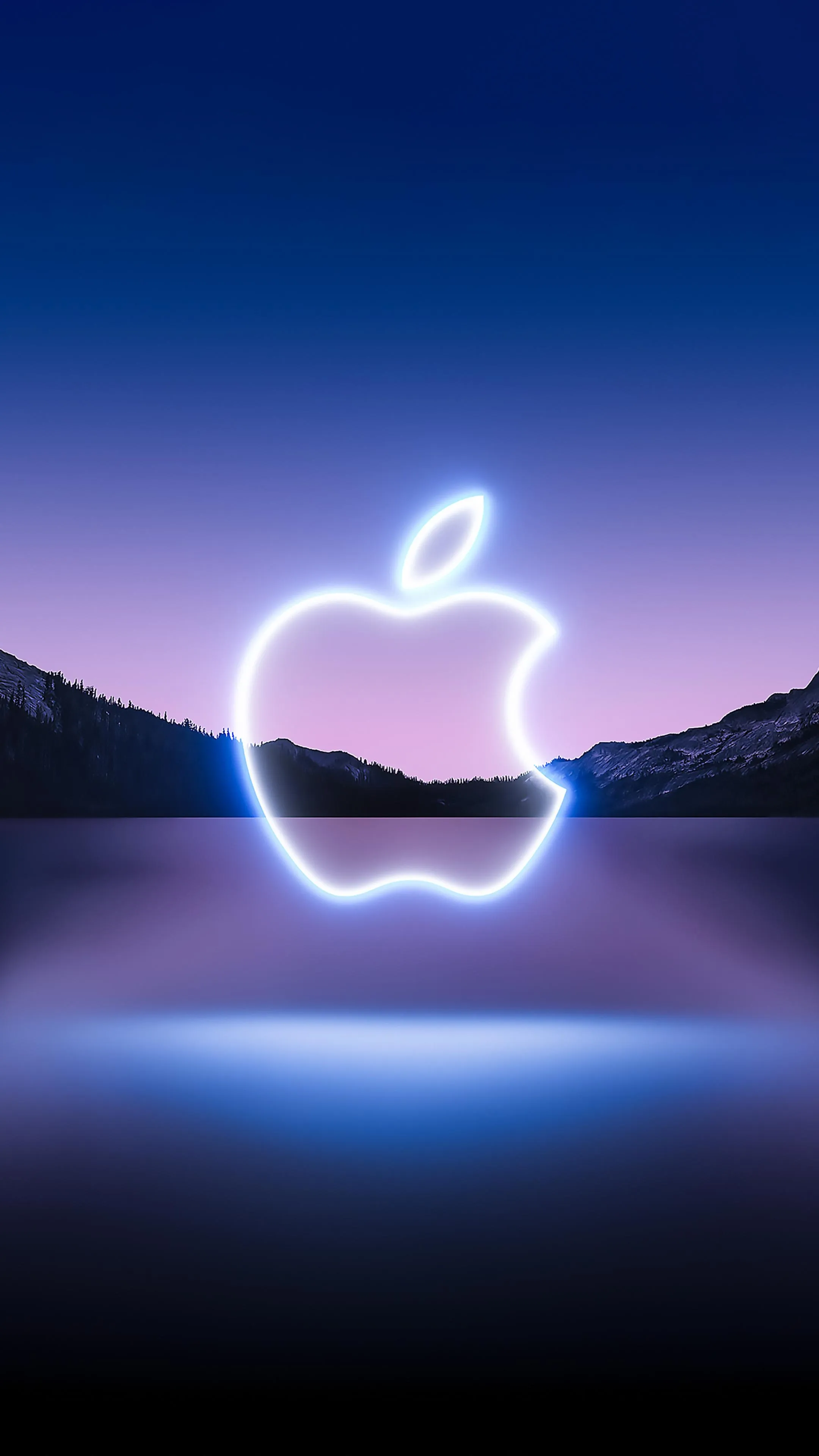 Glowing apple logo with neon reflection on a dark sunset