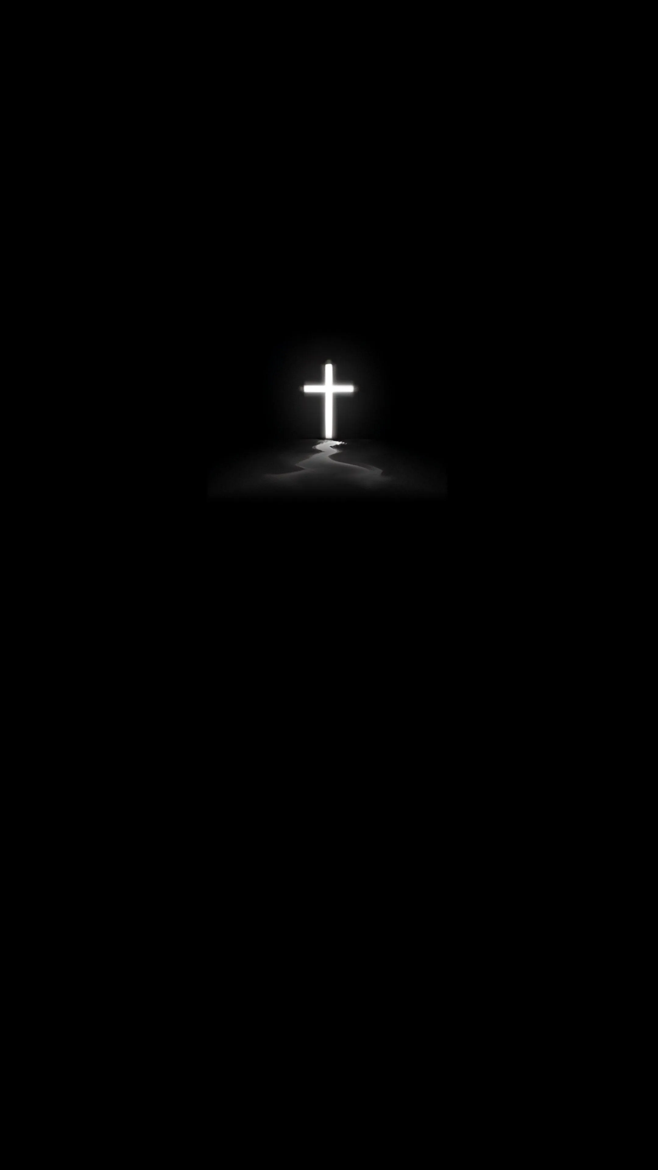 Glowing white cross with light aura on a black background