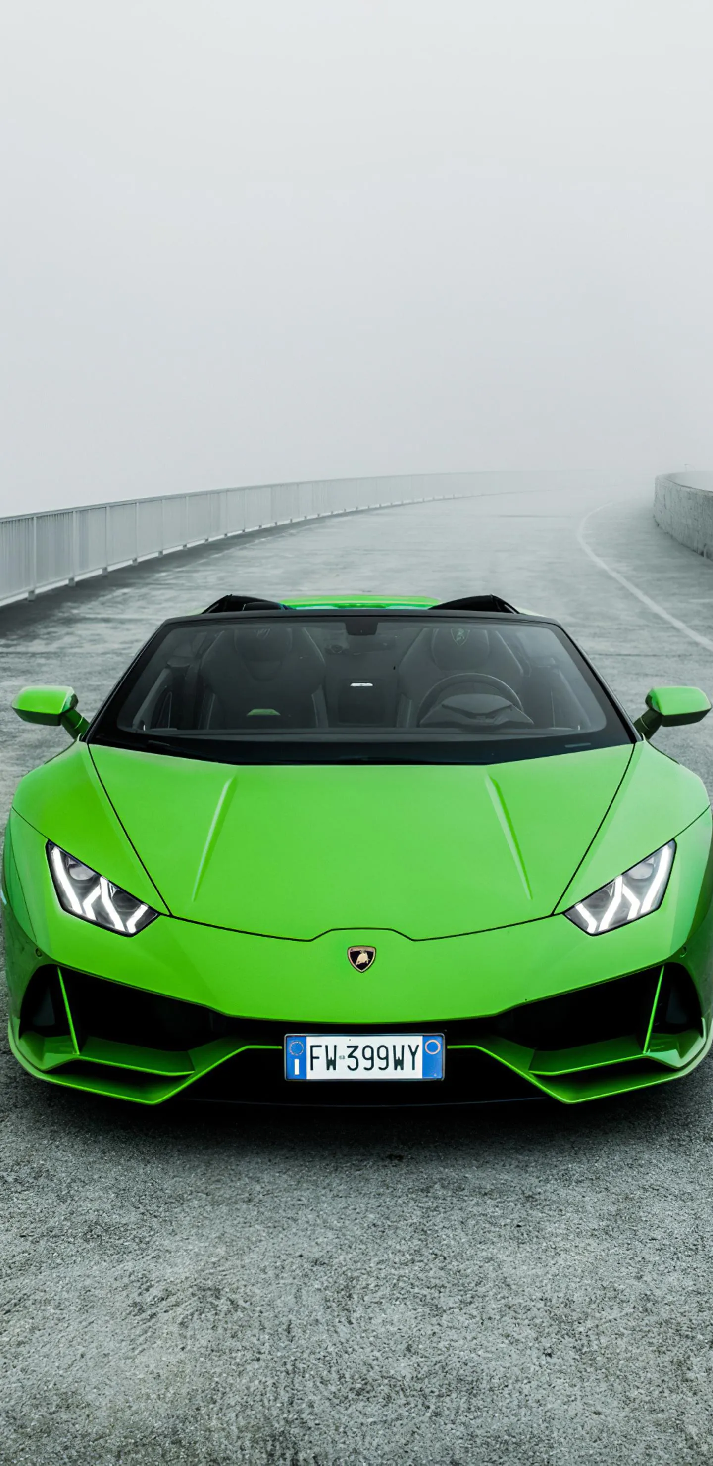 Green Sports Car Parked on Foggy Mountain Road Wallpaper