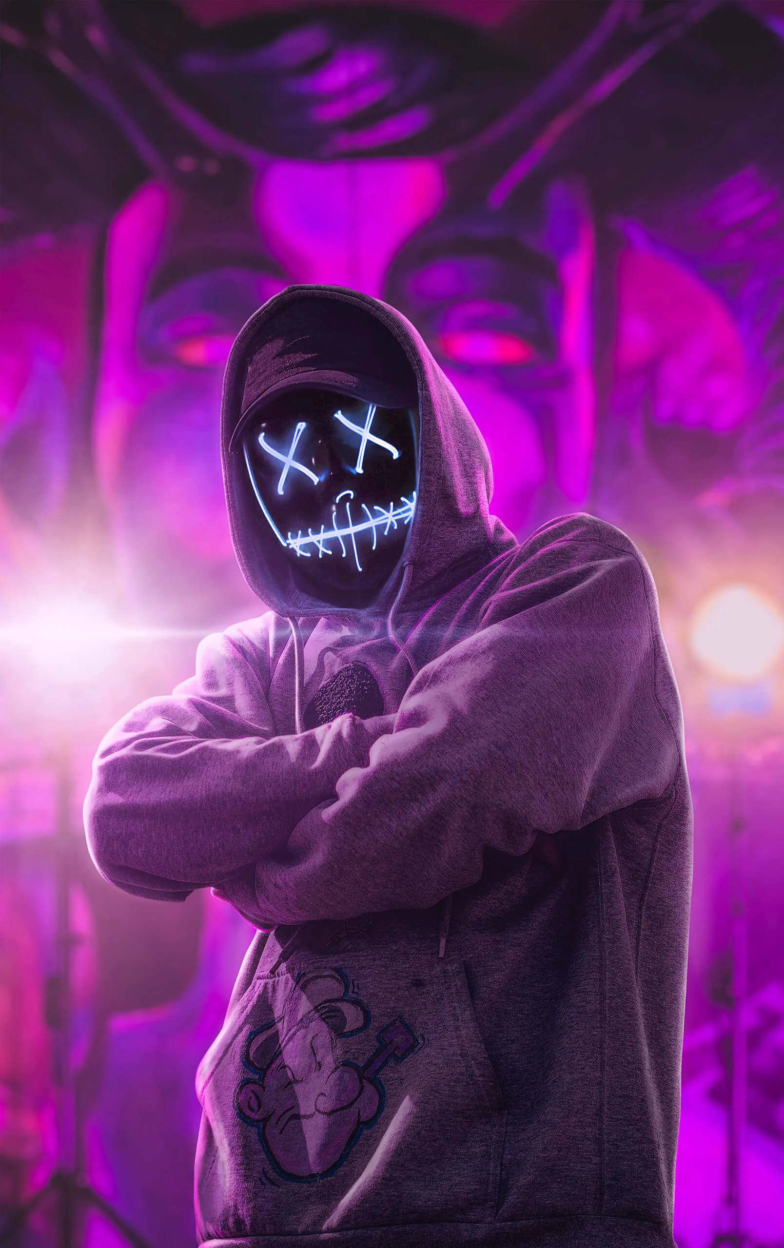 Hooded man in purple neon lights with mysterious mood