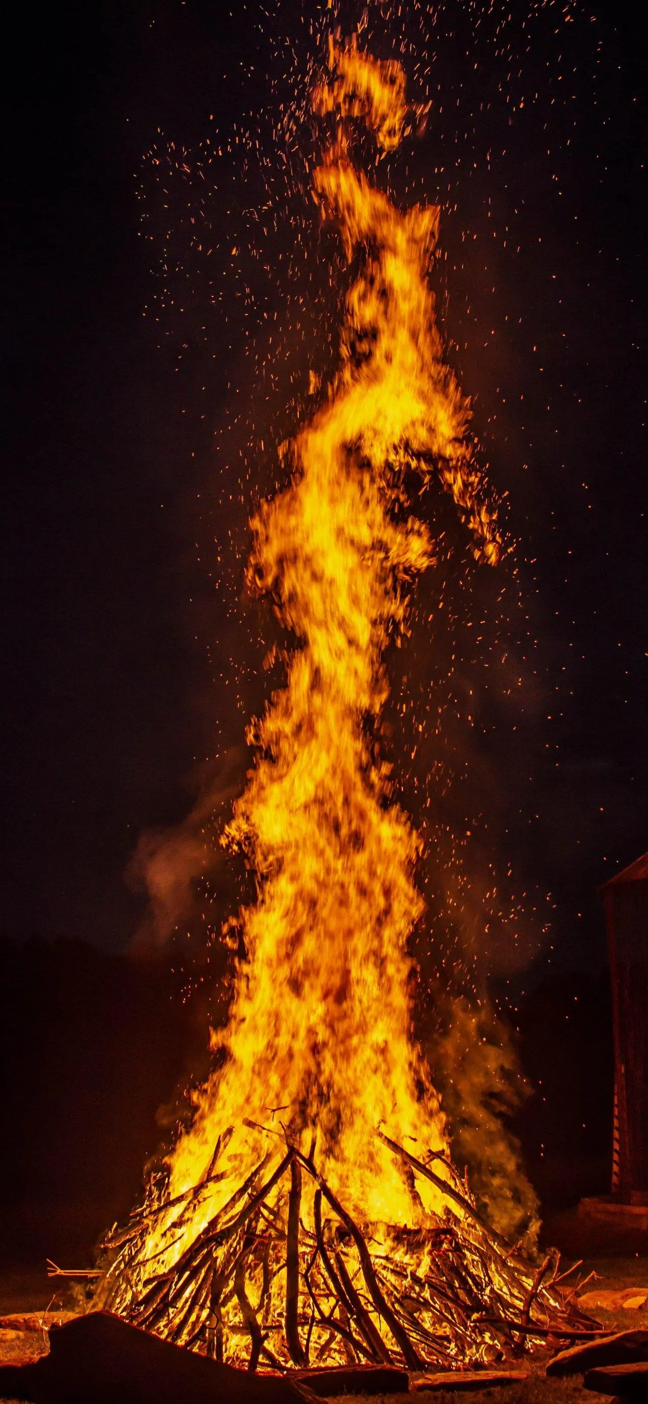 Huge Bonfire Burning Brightly in a Dark Night Landscape