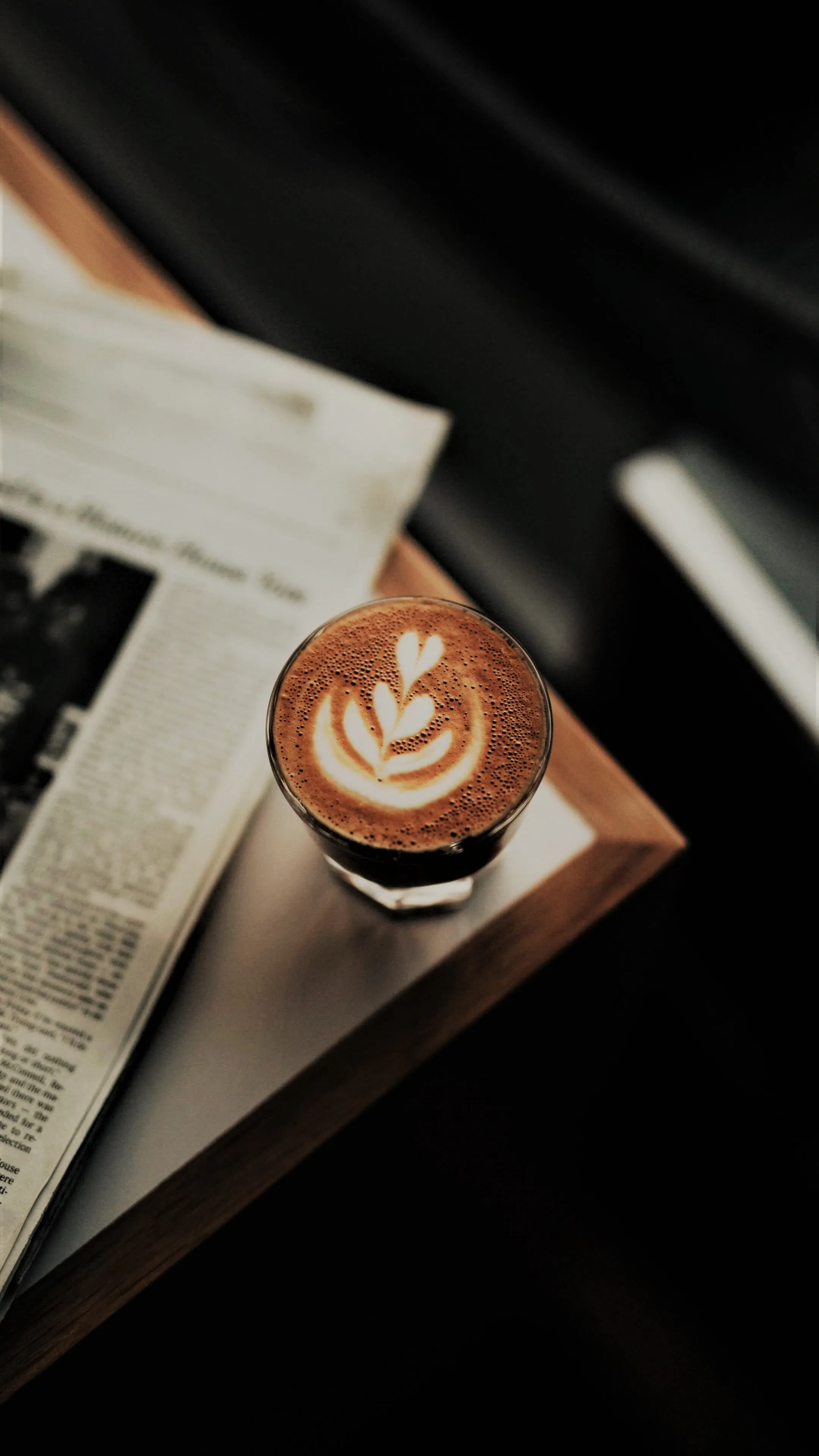 Latte Art Coffee on Table with Book and Relaxing Atmosphere