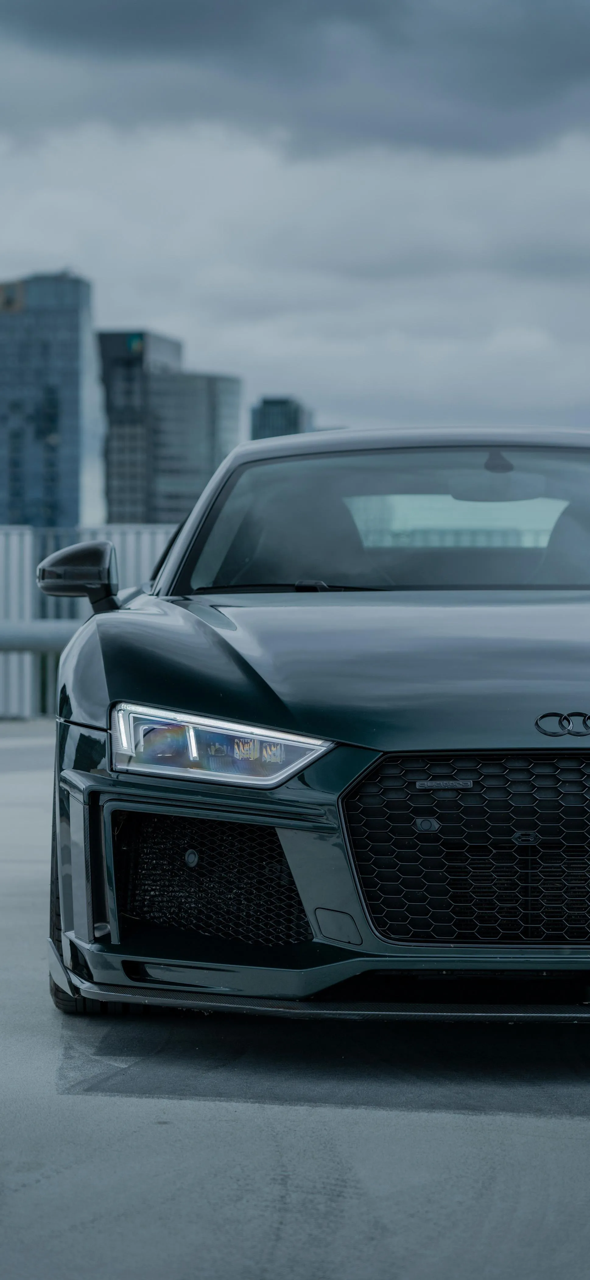 Luxury Black Car in Urban Street with Cloudy Weather