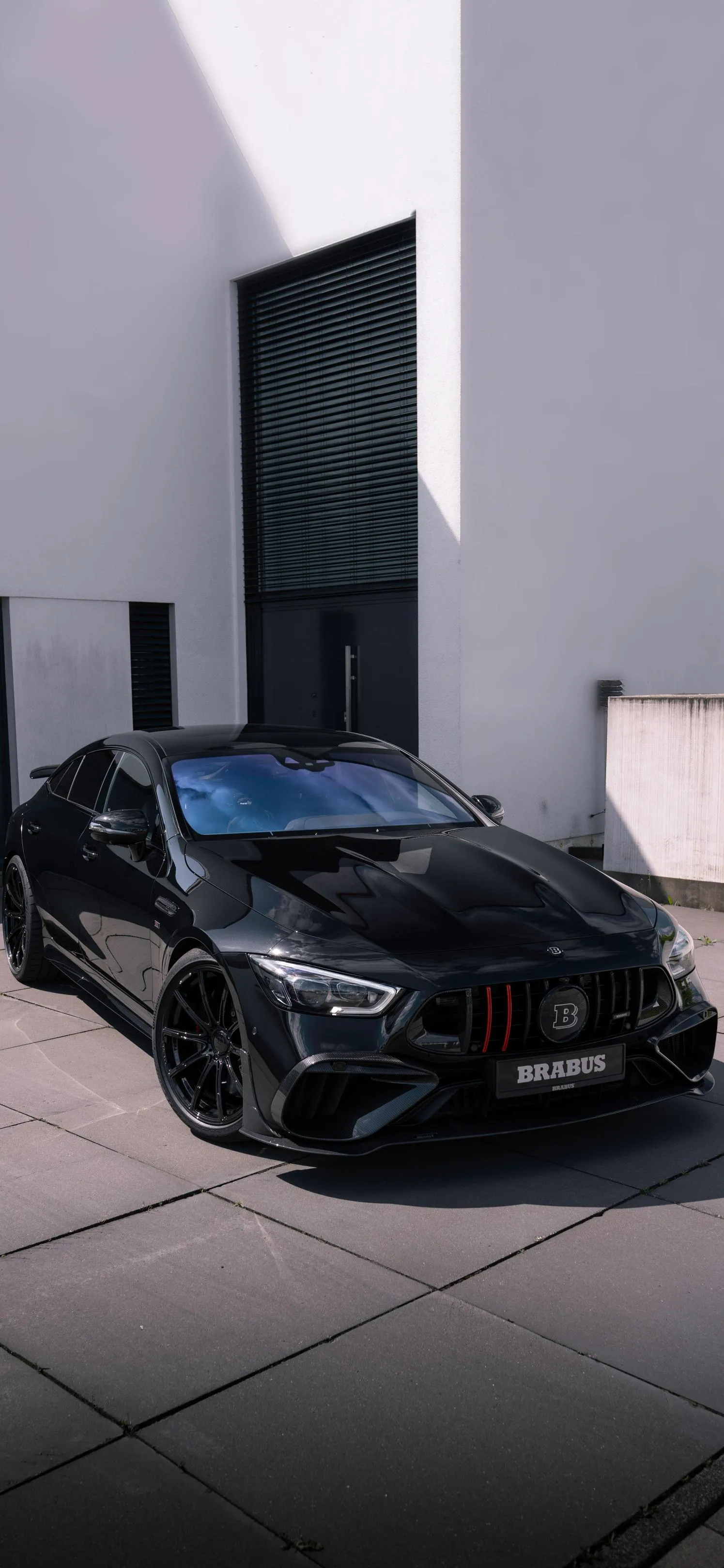 Luxury Black Sports Car Parked in Modern Minimal Driveway