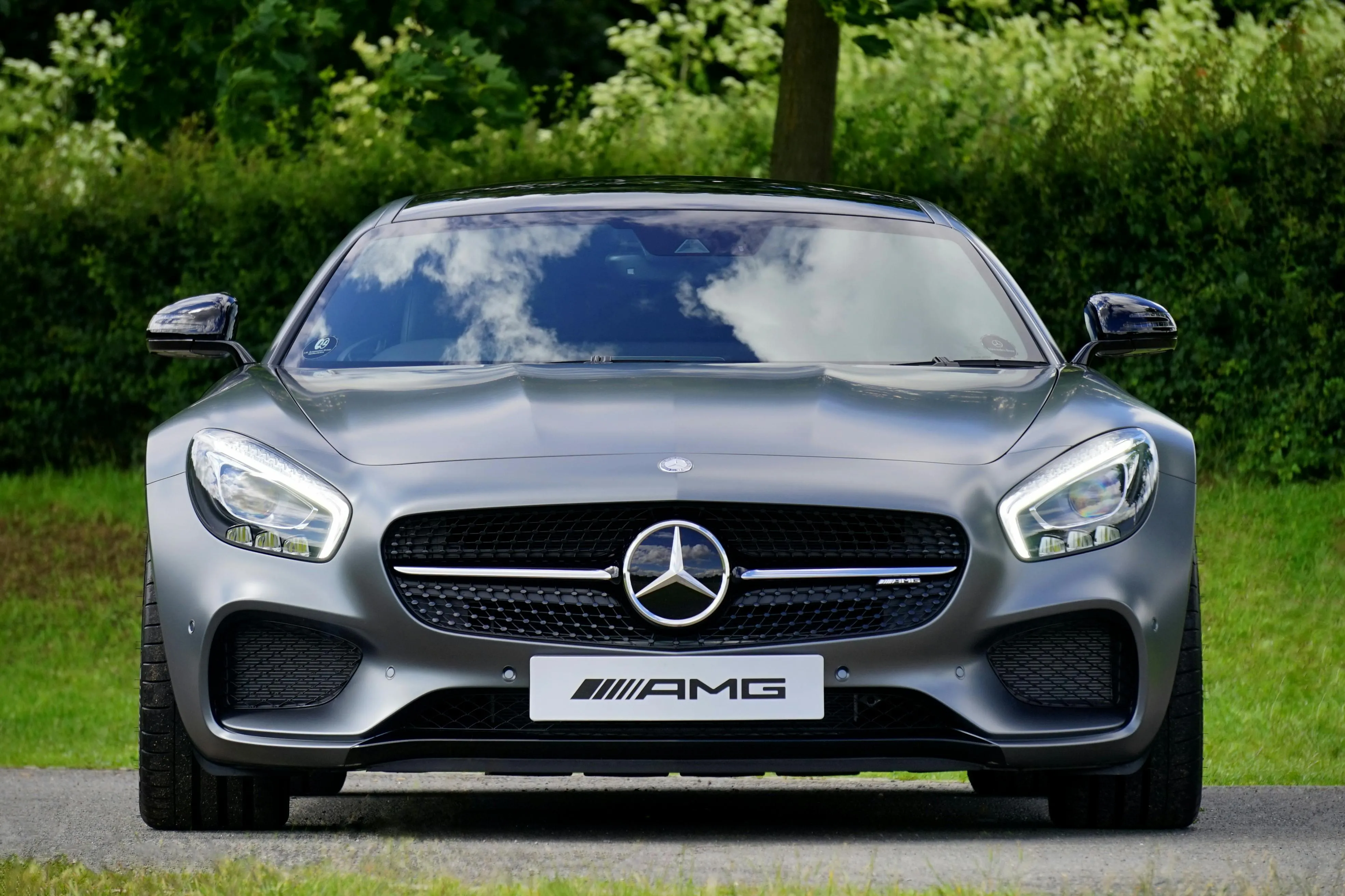 Luxury Mercedes AMG sports car front view in green nature
