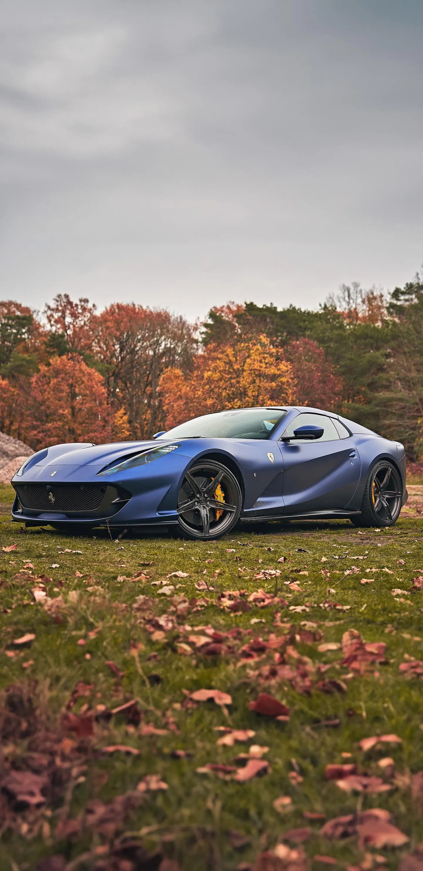 Luxury sports car parked in autumn countryside Wallpaper