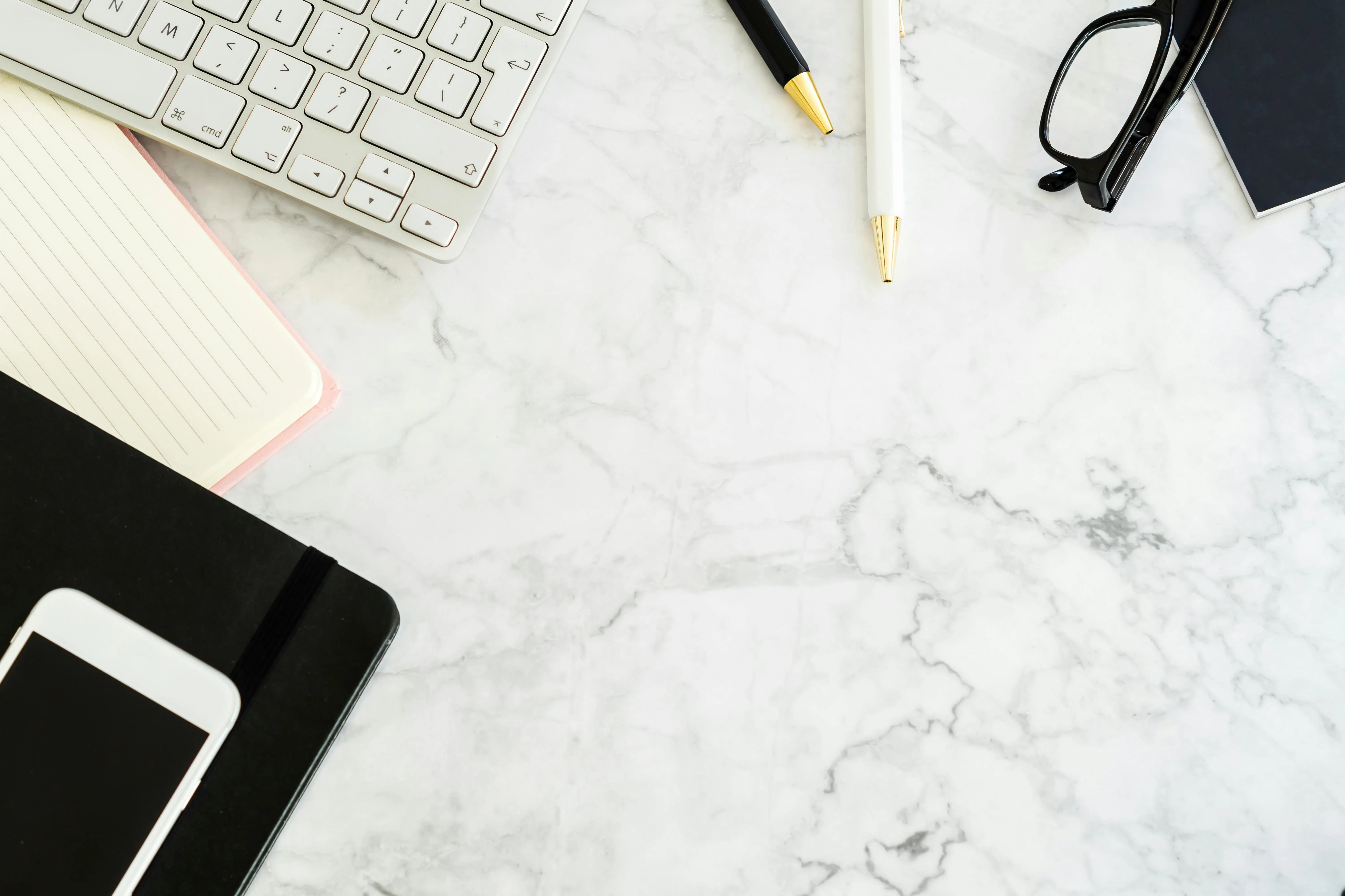 Minimal workspace flat lay on white marble desk background