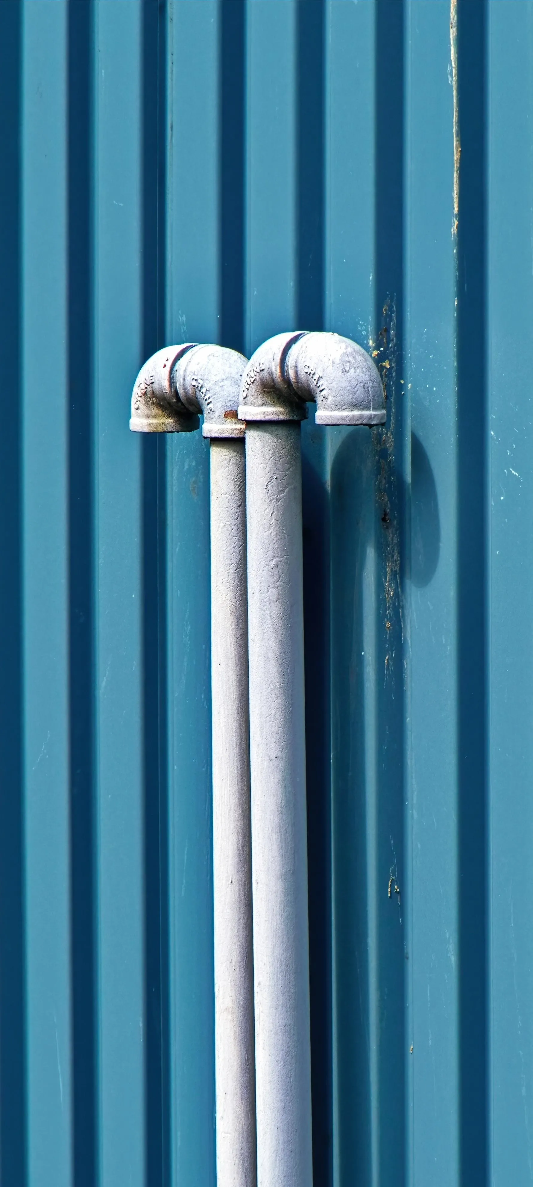 Minimalist Industrial Pipes on Vertical Blue Background