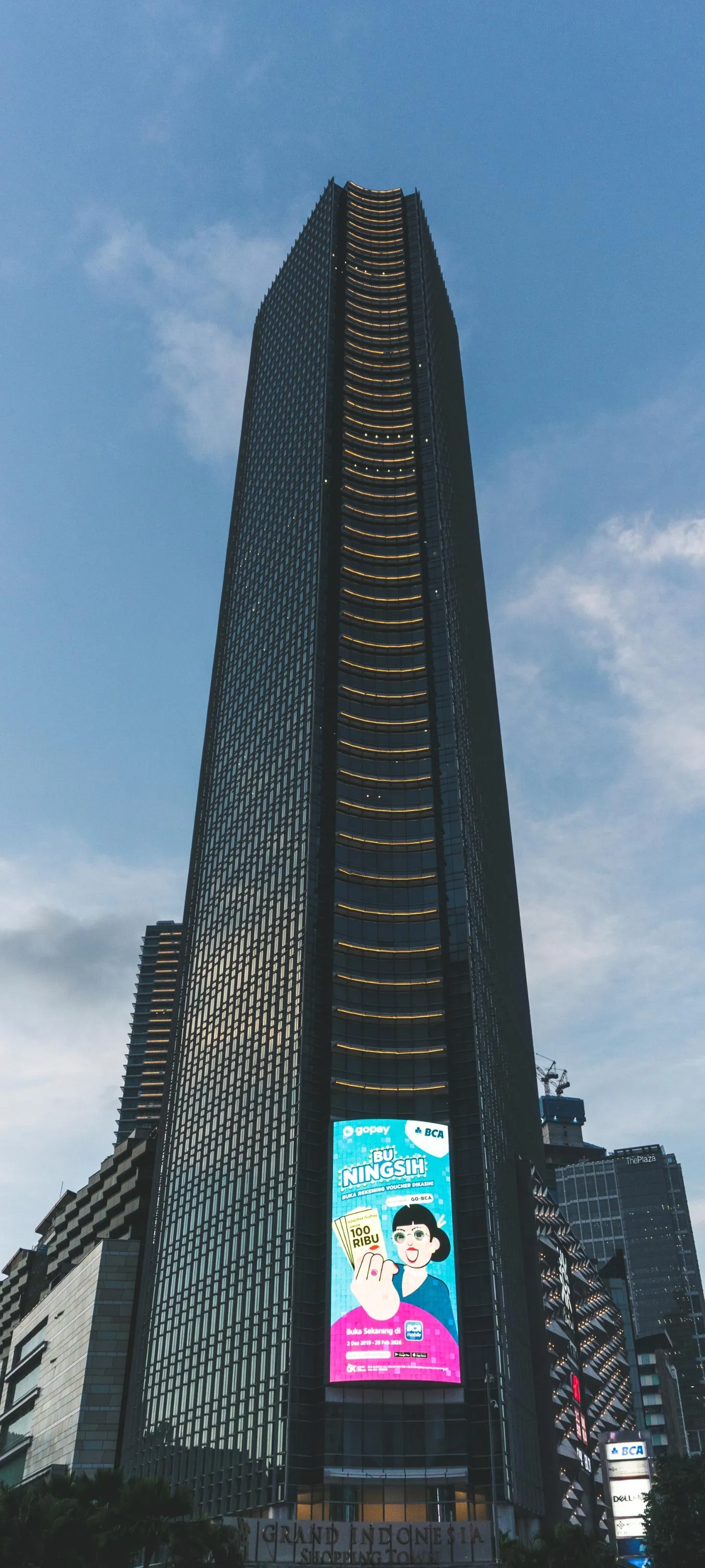 Modern Glass Skyscraper Tower Against Clear Blue Sky