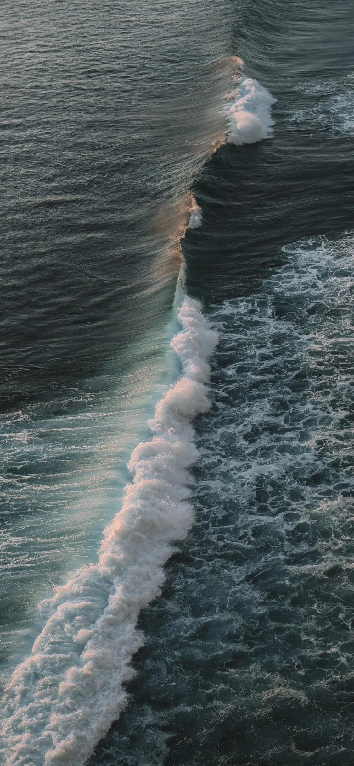 Moody Ocean Waves Crashing with Gentle Sunset Light