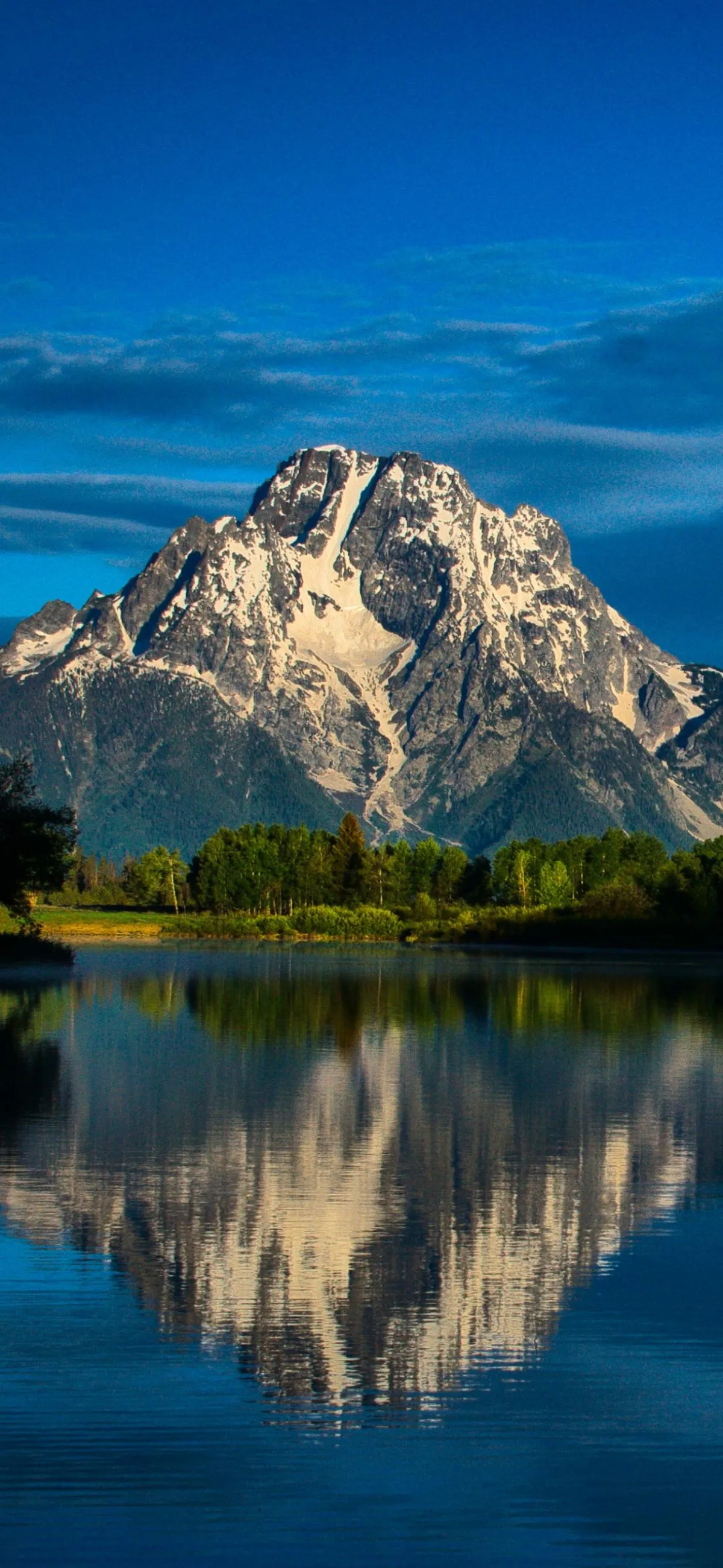 Mountain reflected on lake under clear blue sky Wallpaper