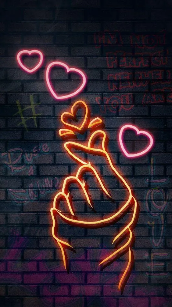 Neon light hand gesture with hearts on a dark brick wall