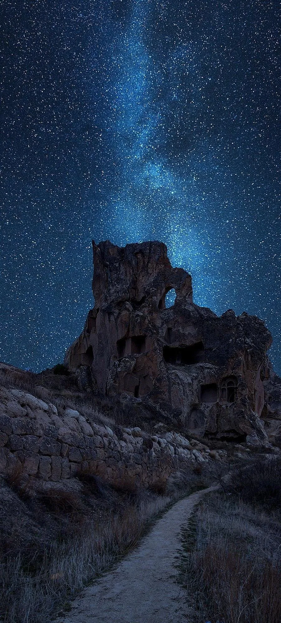 Night Castle Under Starry Sky in Mysterious Landscape