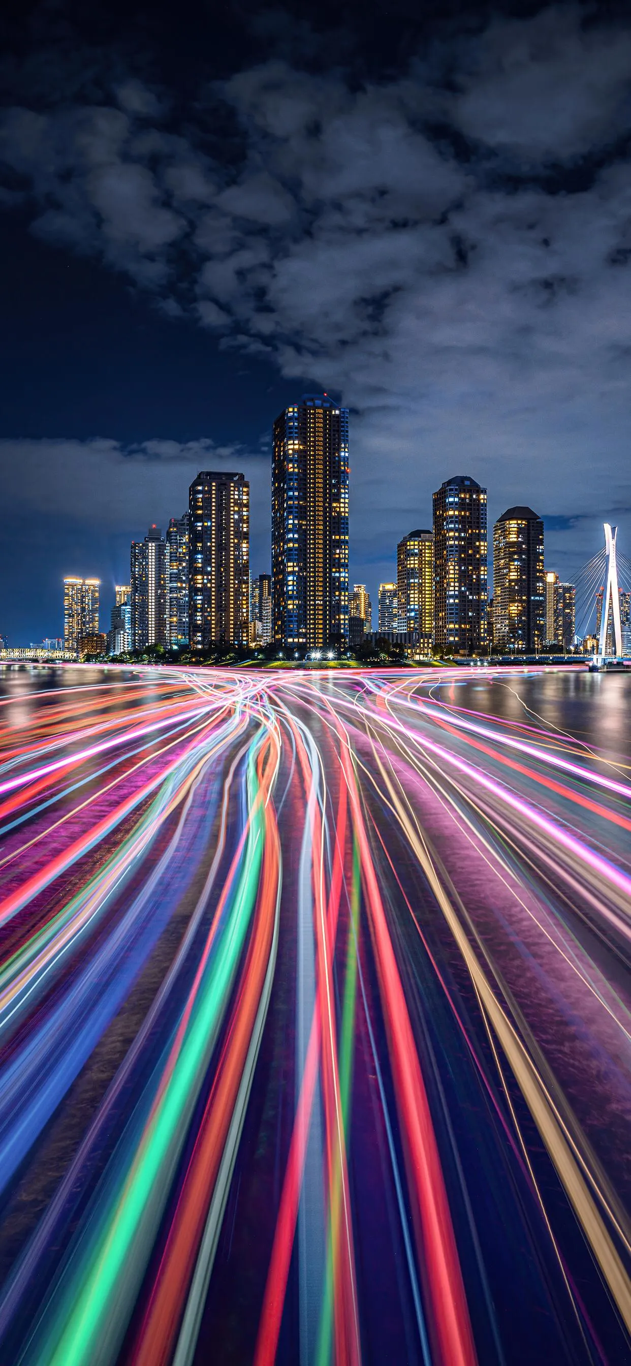 Night cityscape with colorful light trails on highway