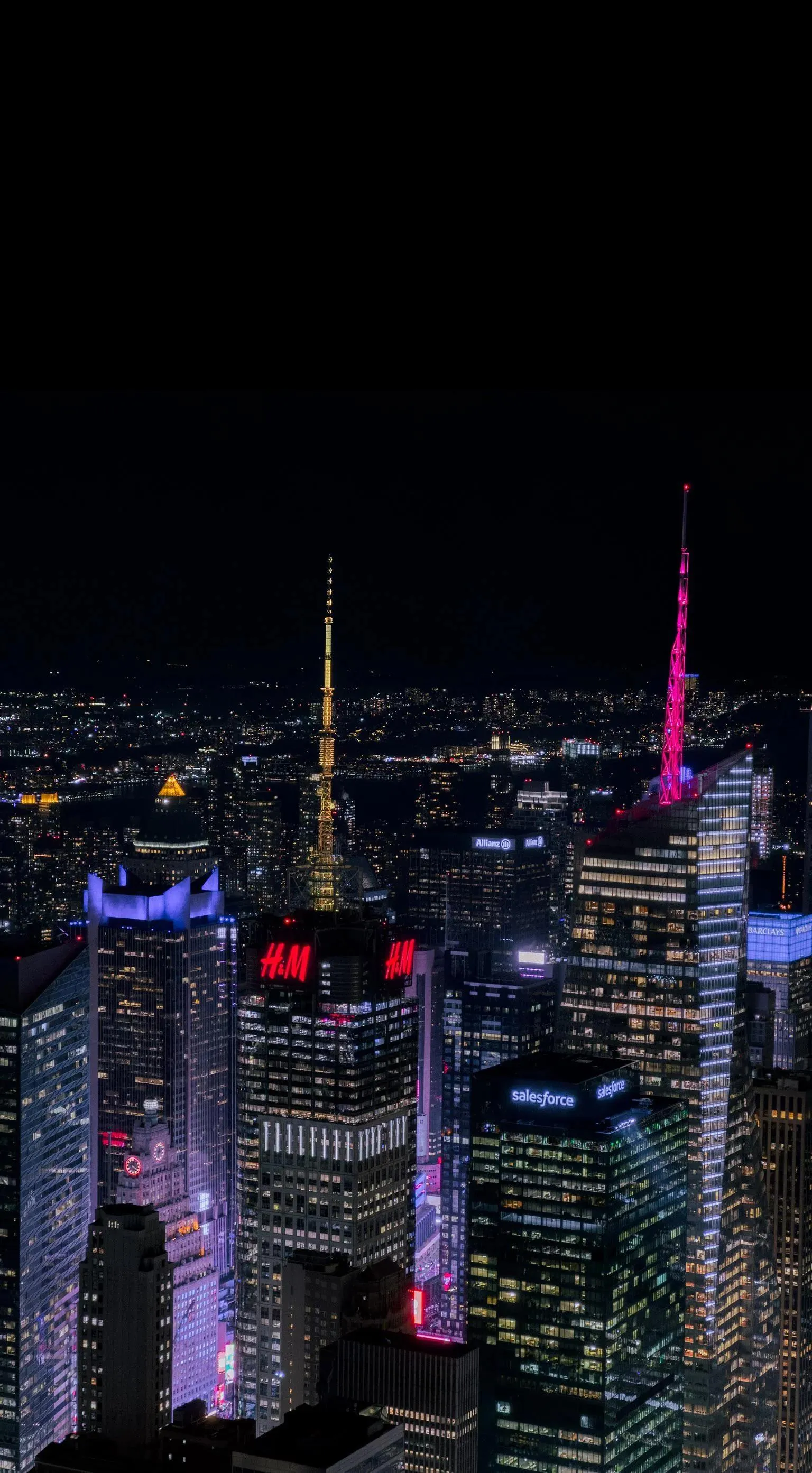 Night cityscape with illuminated buildings and dark sky