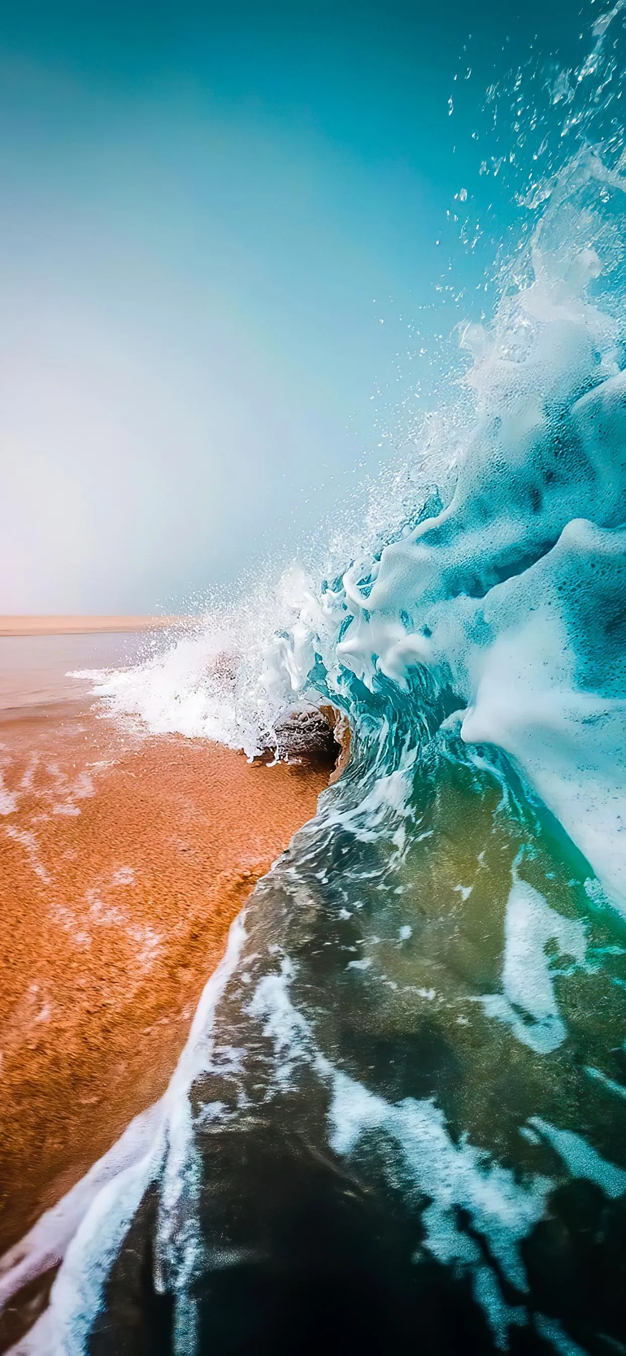 Ocean wave crashing under bright sky for beach lovers