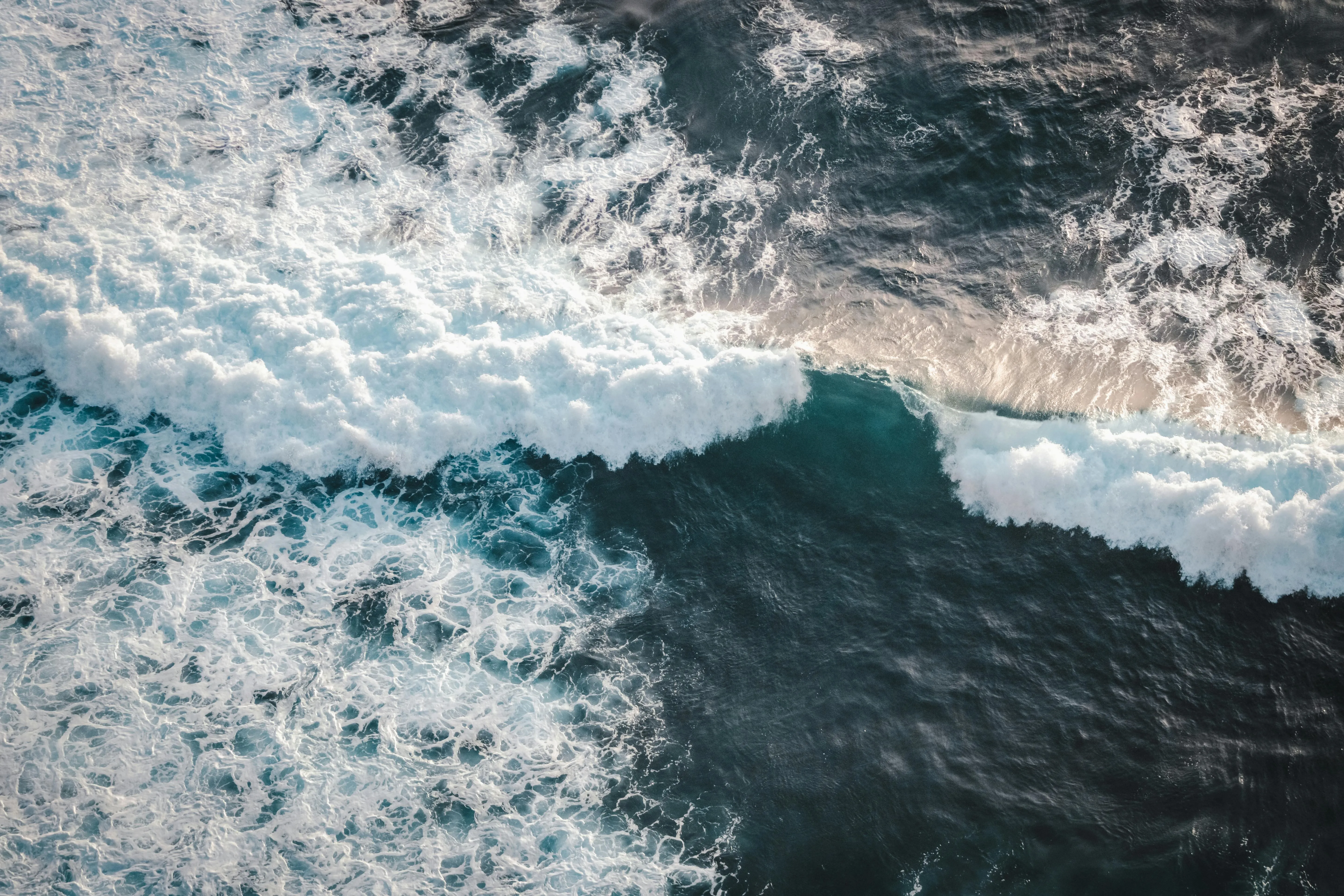 Ocean waves crashing creating white foam and blue water