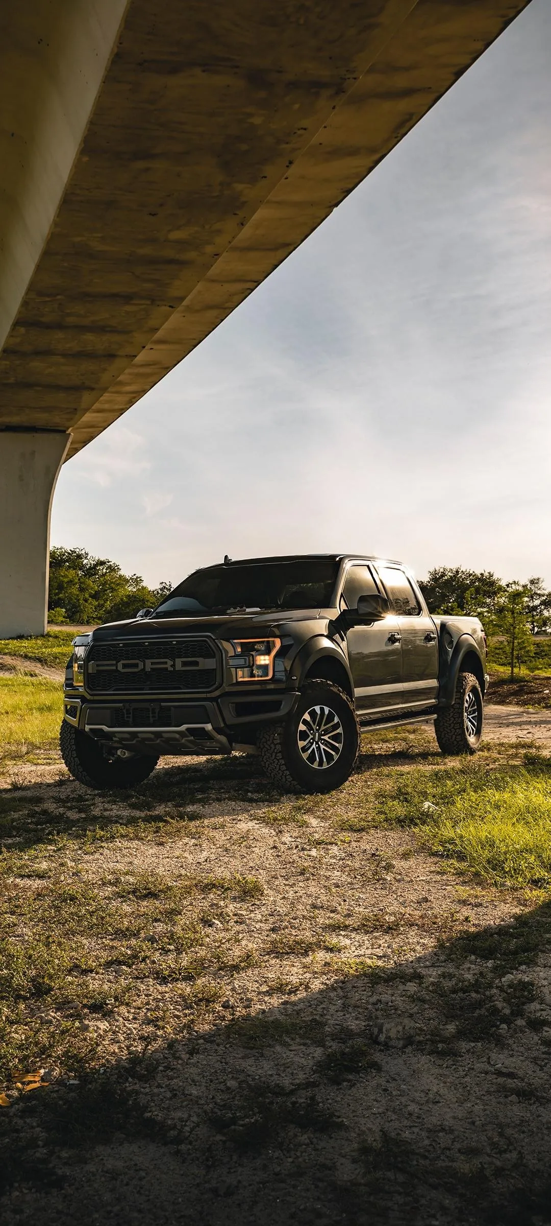 Off Road SUV Parked Under Bridge on a Sunny Day Wallpaper