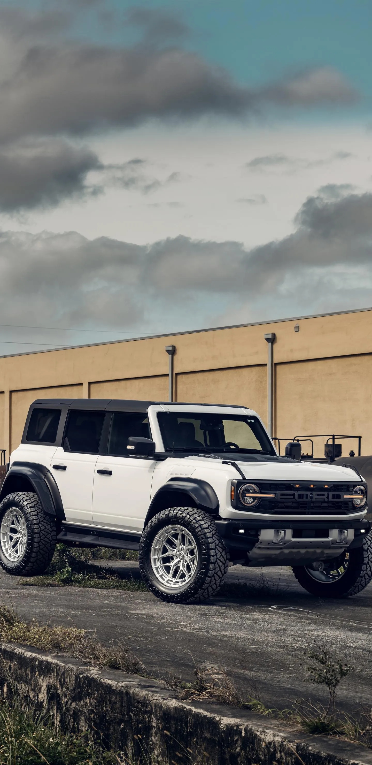 Off Road Vehicle Parked Near Desert Road with Blue Sky