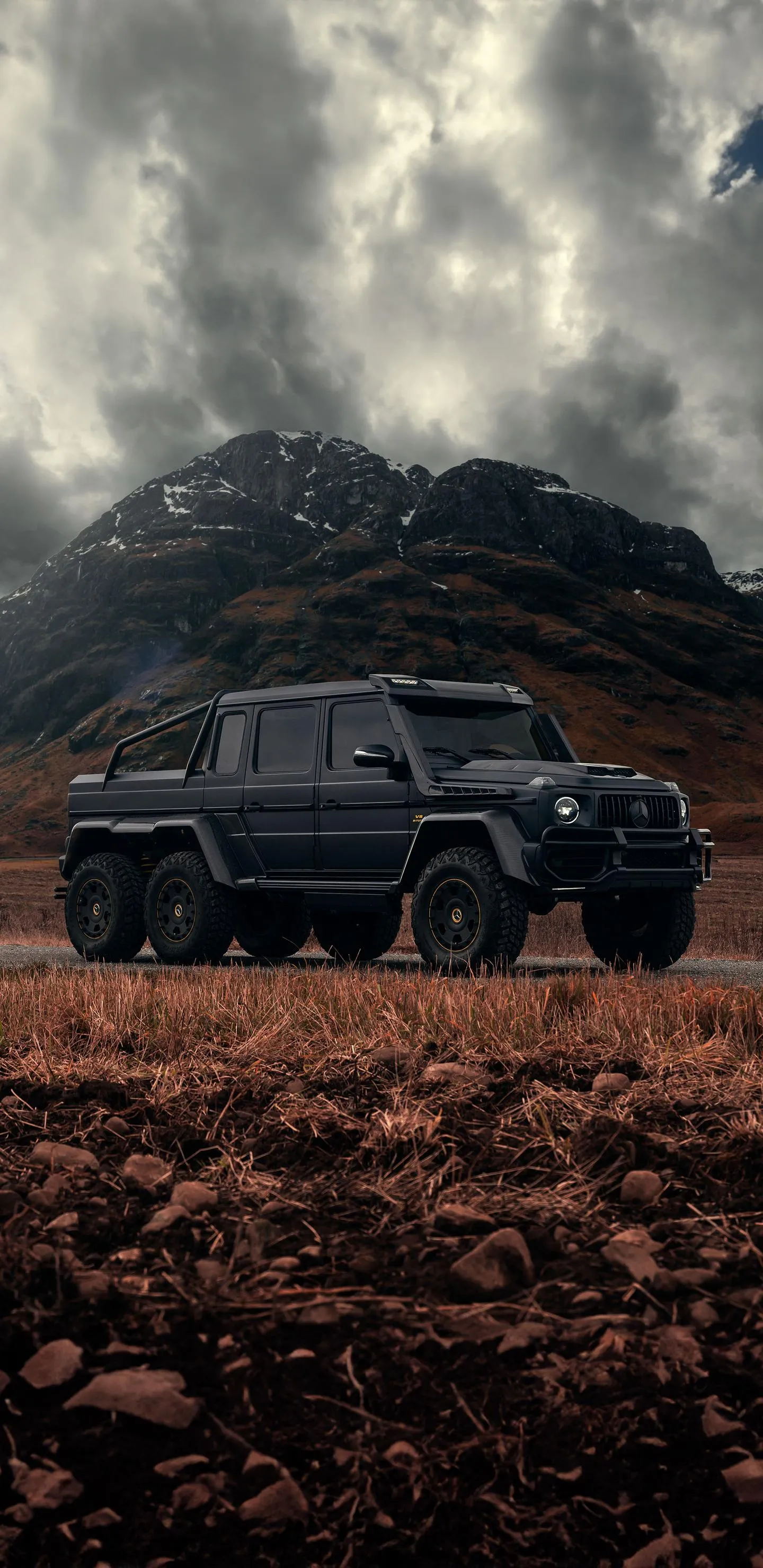 Offroad Vehicle Driving in Dust Under Stormy Sky Wallpaper