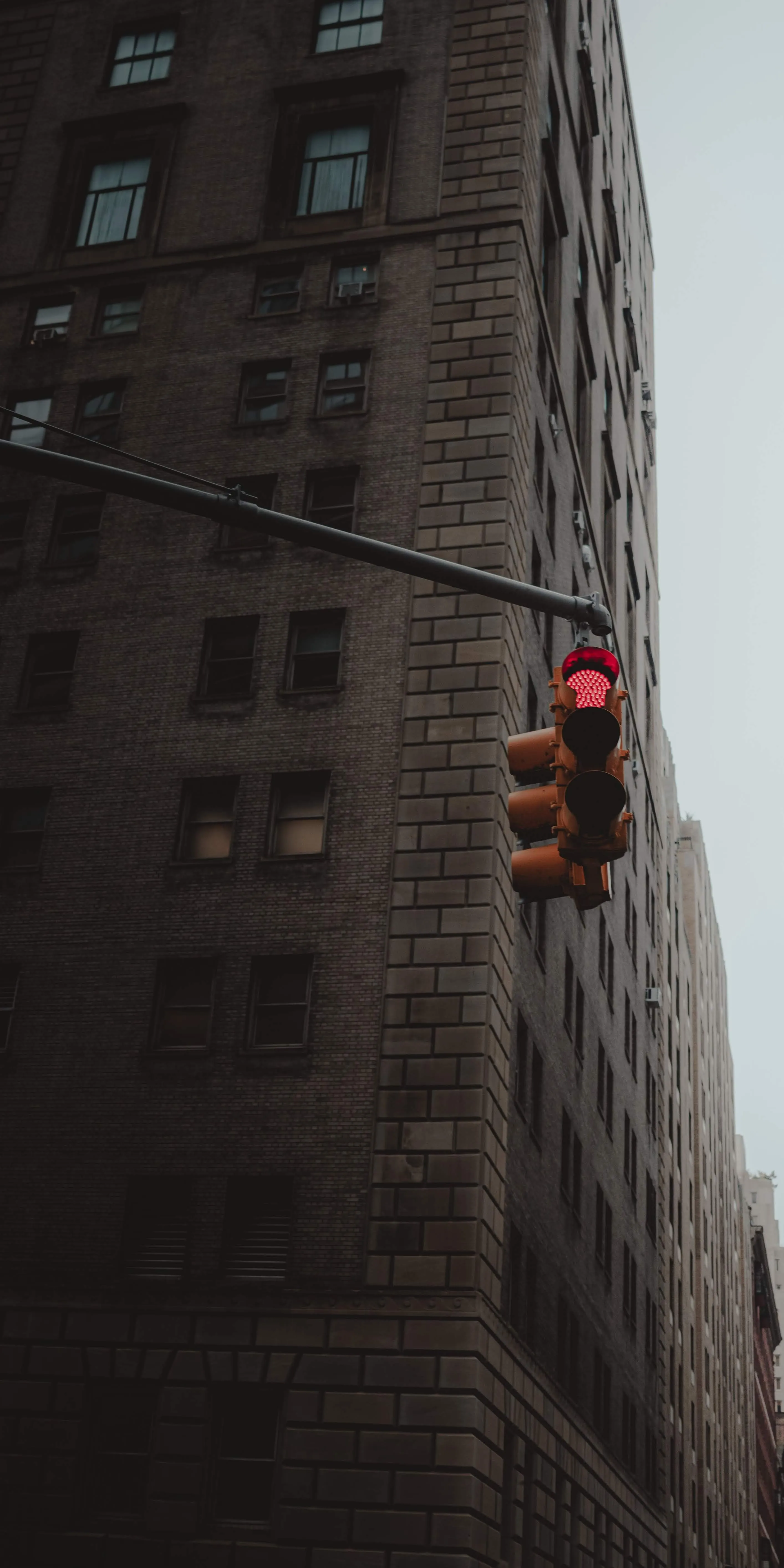 Old city street with tall buildings and traffic light