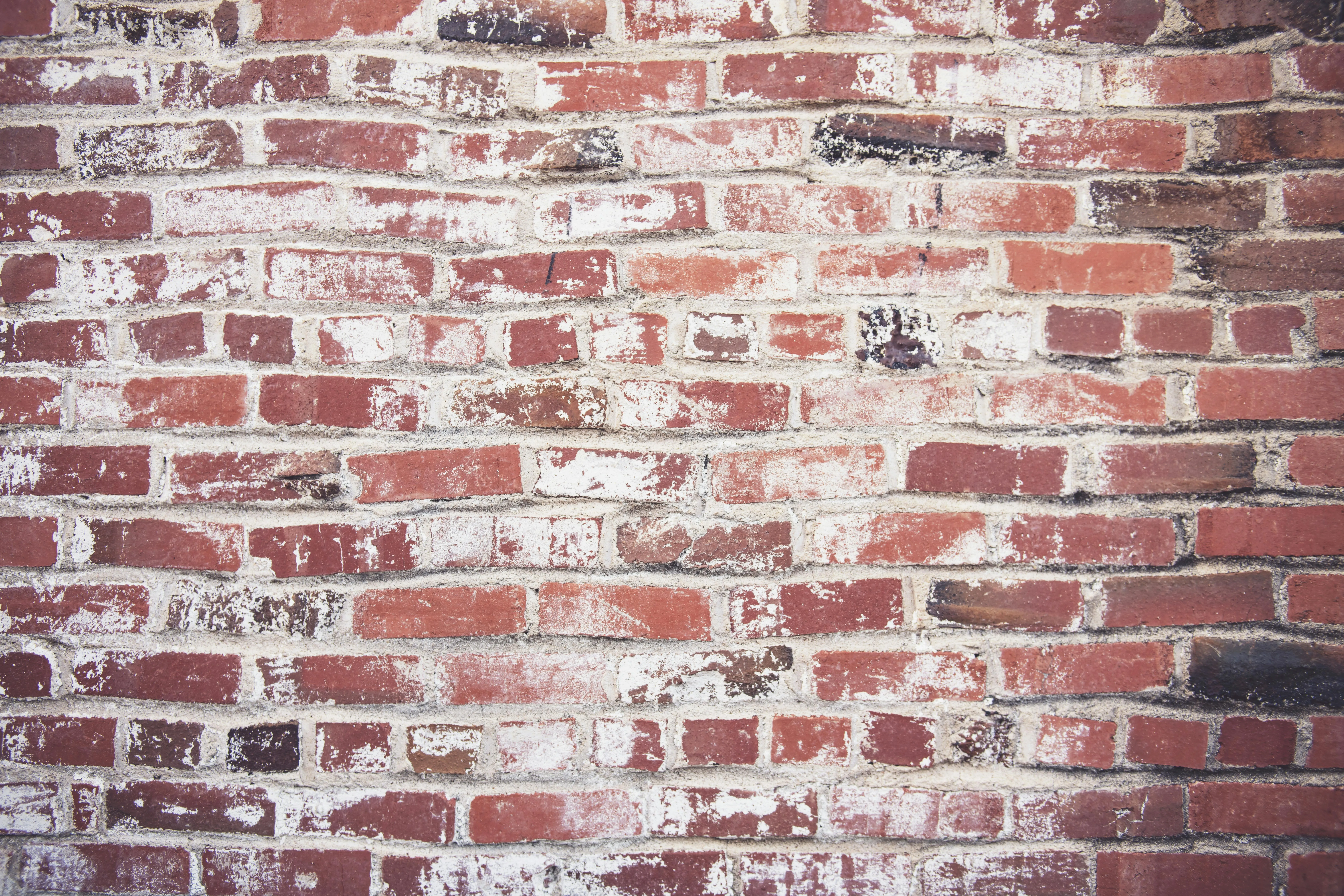 Old red brick wall with faded paint texture background HD