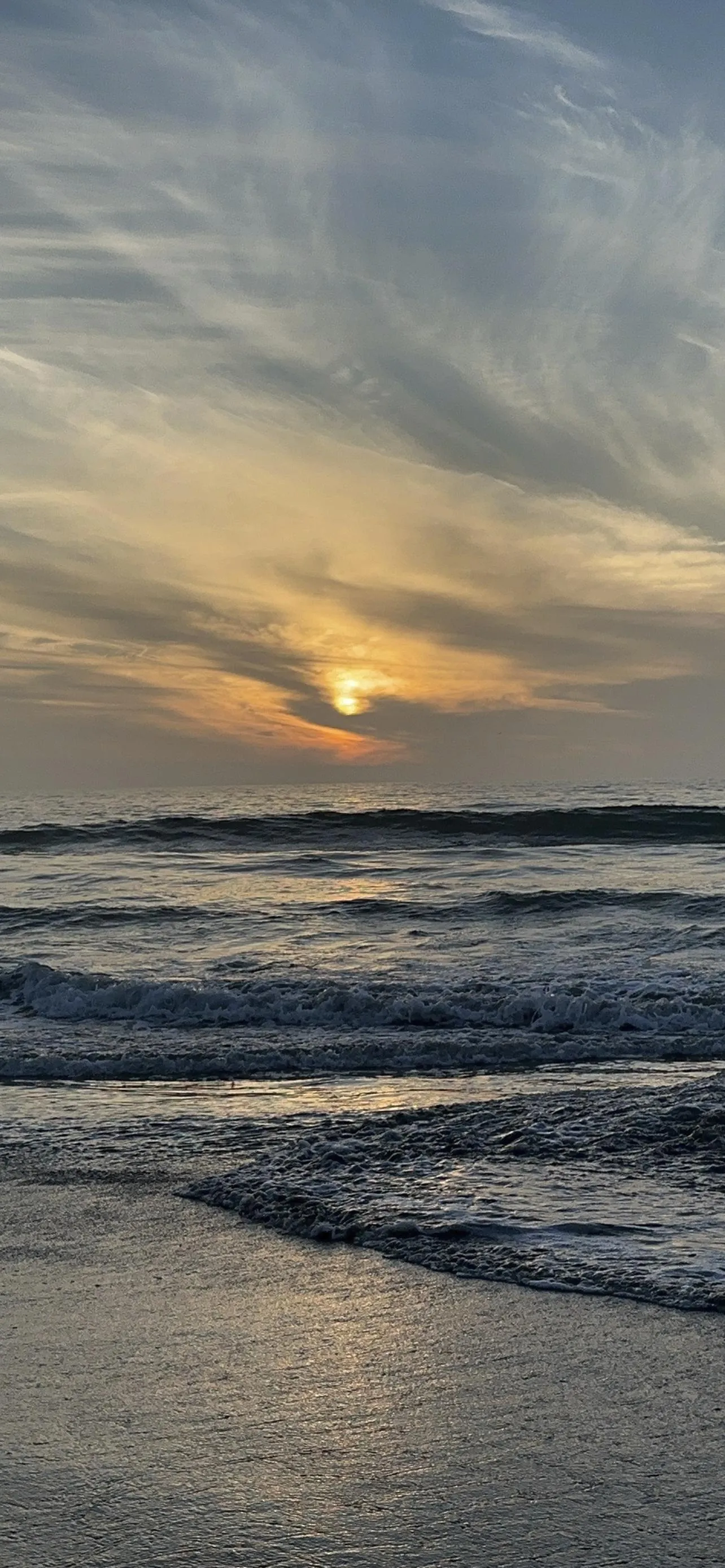 Peaceful Ocean Sunset with Gentle Waves and Clouds Wallpaper