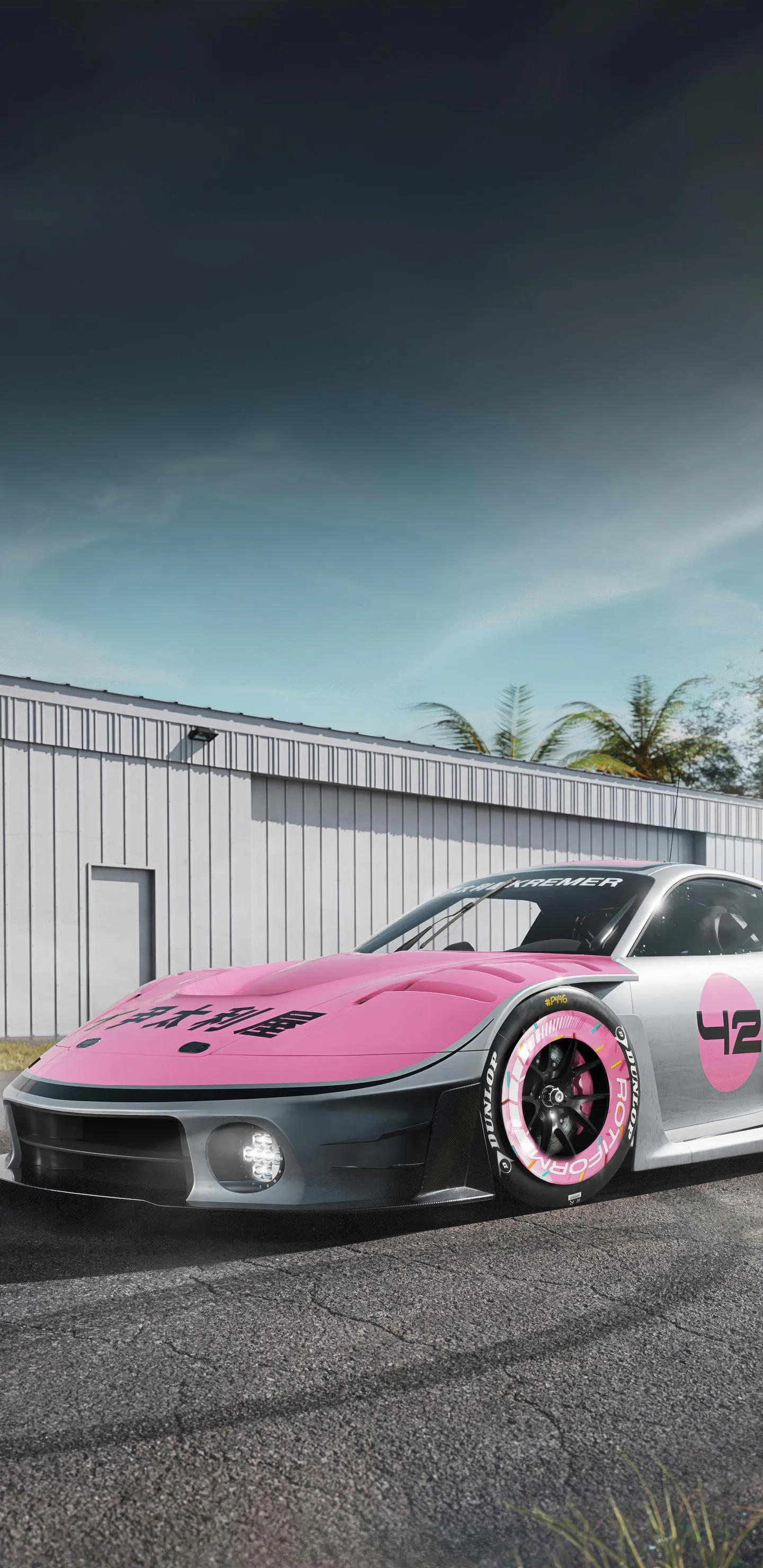 Pink Sports Car Parked Near Building Under Clear Blue Sky Mobile