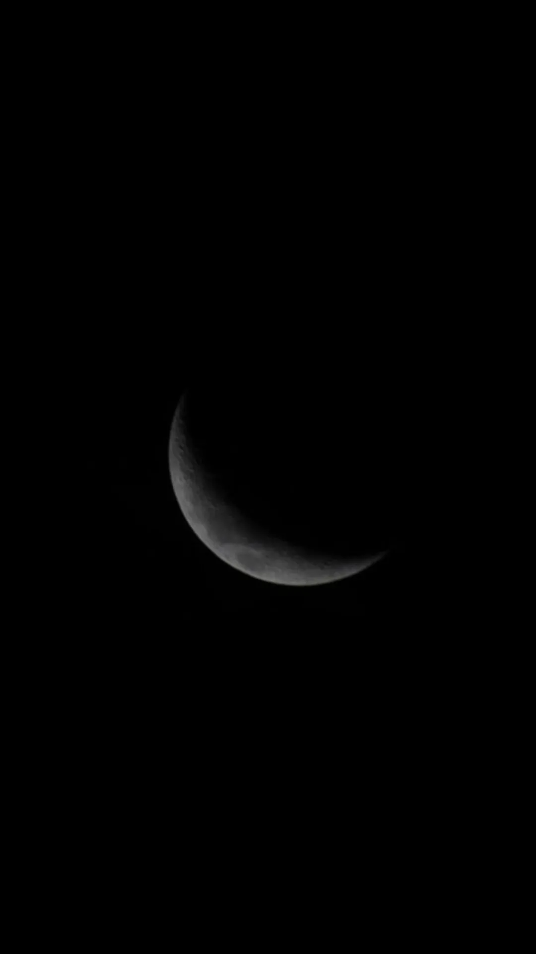 Portrait of Dark night sky with a glowing crescent moon