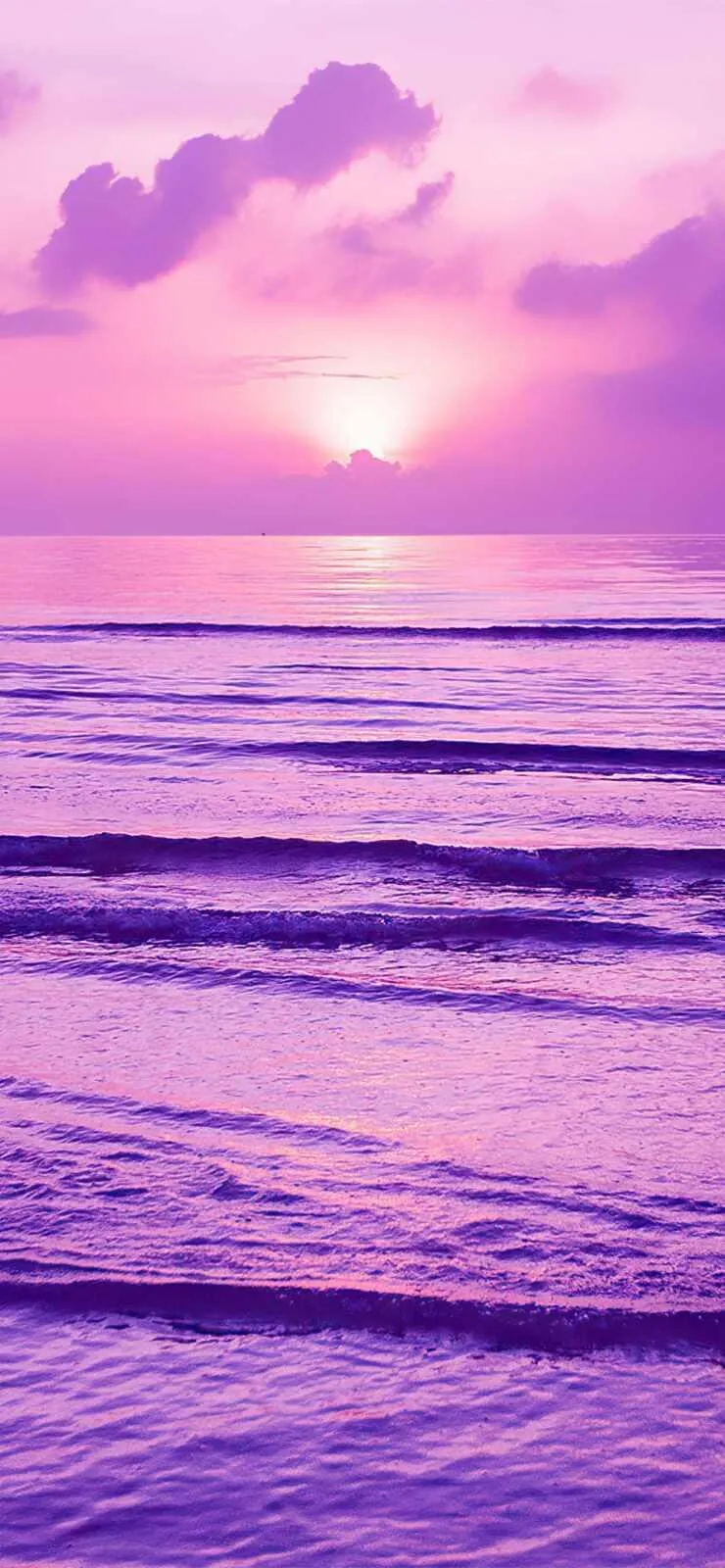 Purple beach sunset with ocean waves and clouds Wallpaper