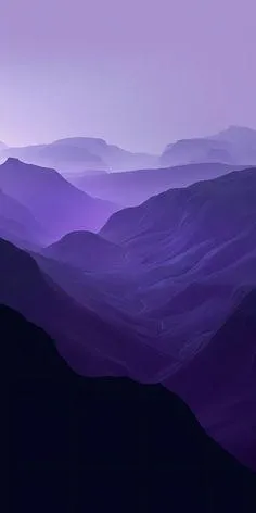 Purple mountain landscape with layers fading into soft sky