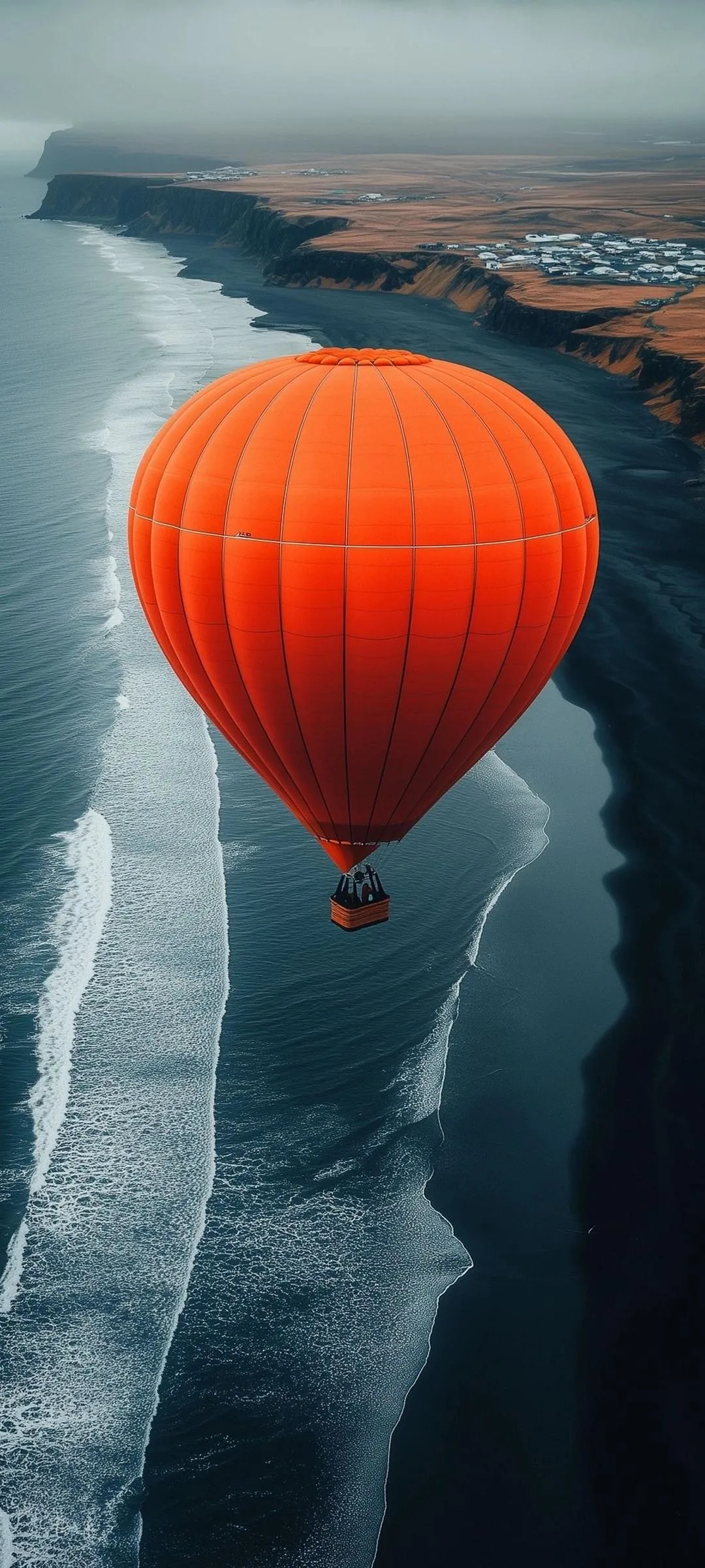Red Hot Air Balloon Flying Over Snowy Mountainscape