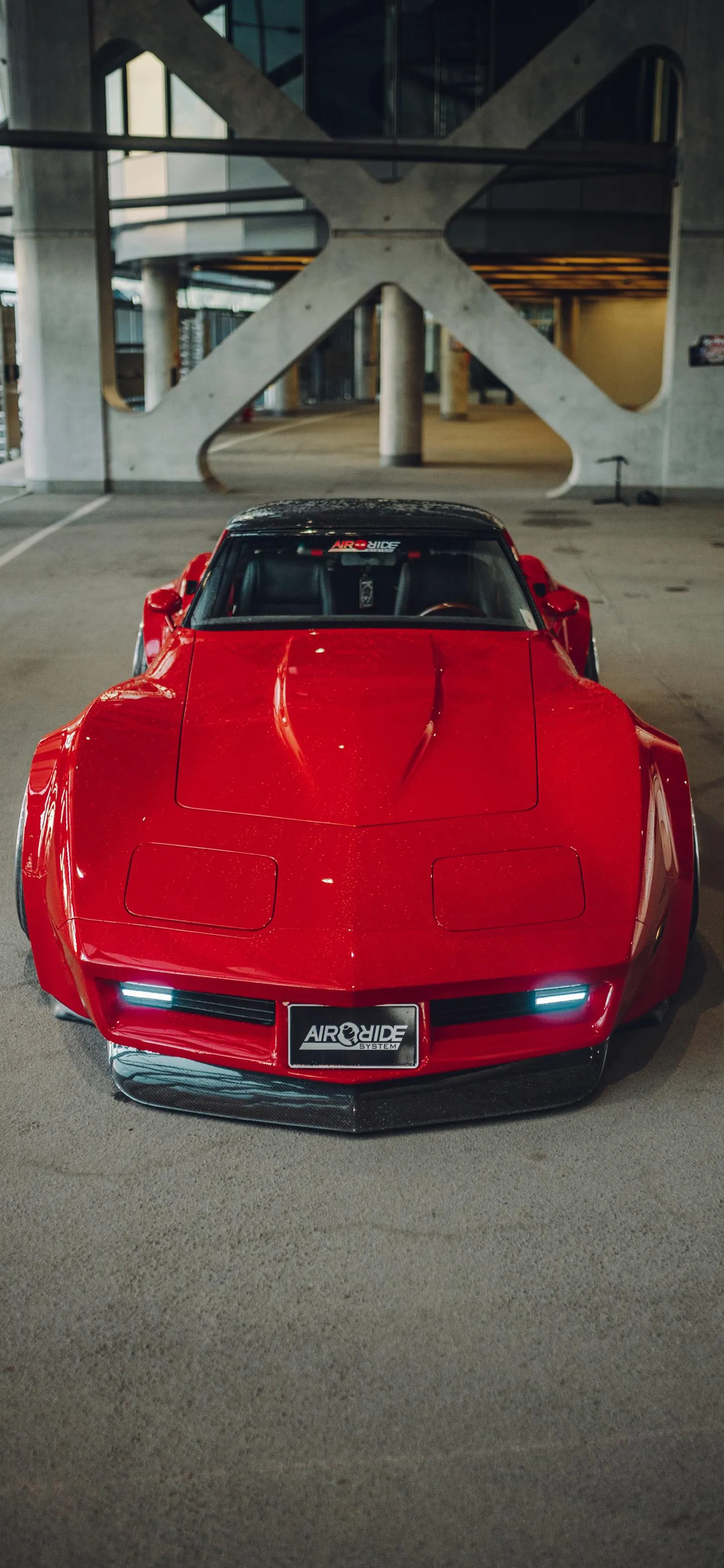 Red Sports Car Displayed in Indoor Parking Area Wallpaper