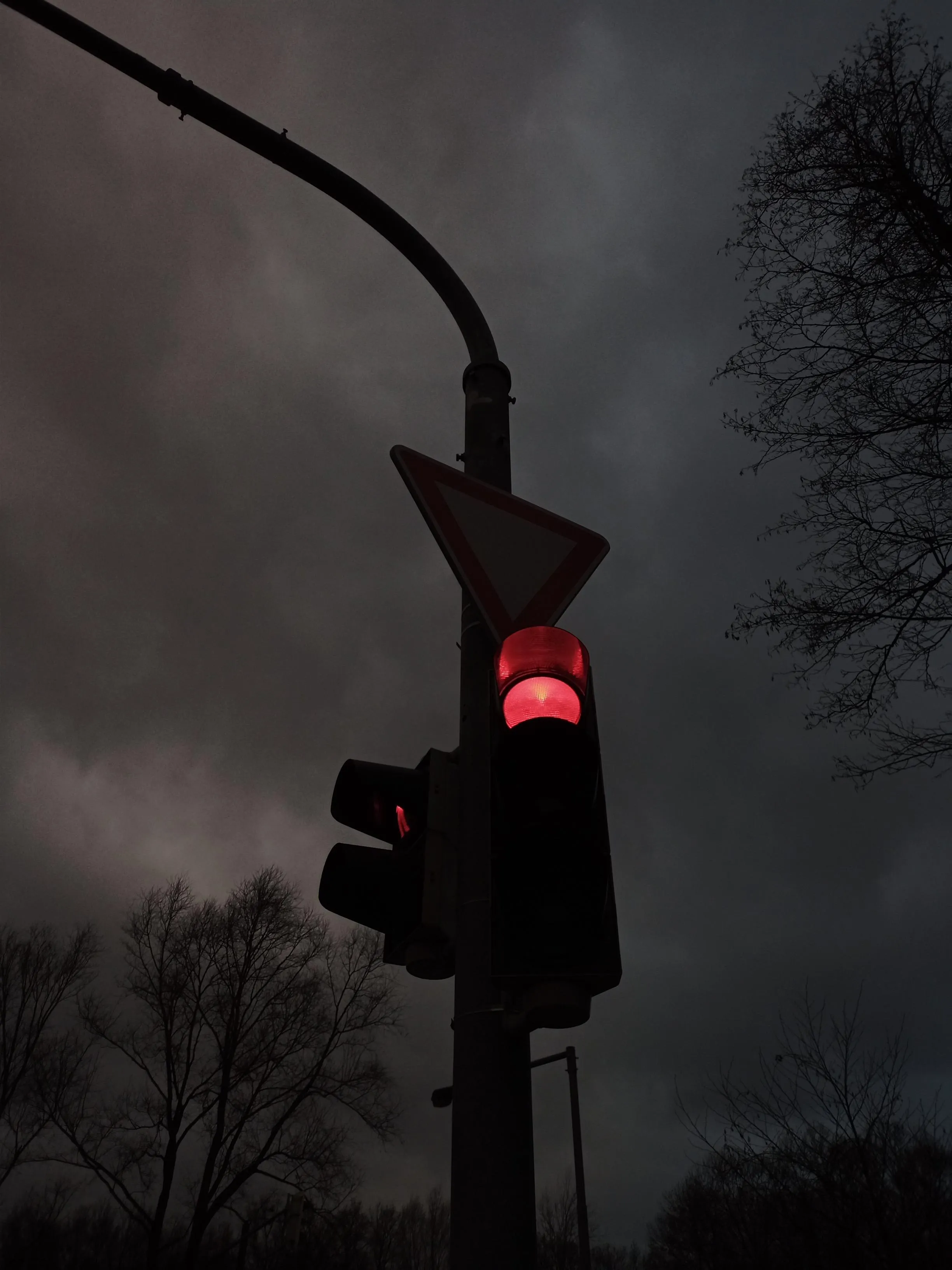 Red Traffic Light in Foggy Night with Moody Atmosphere