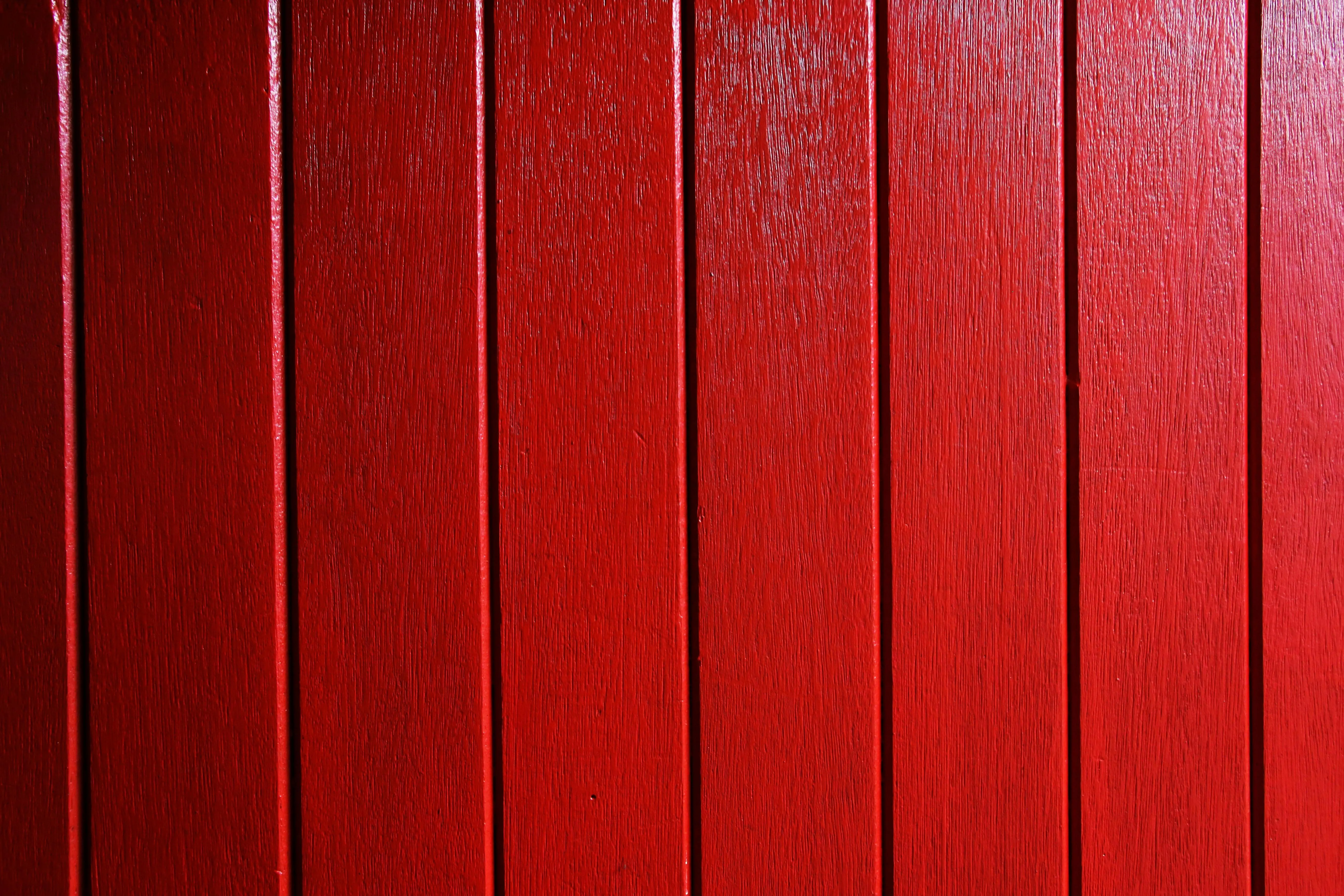 Red wooden panel wall texture with grain lines Wallpaper